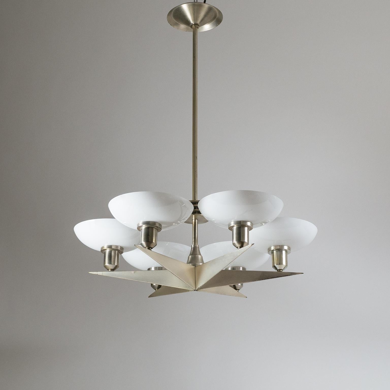 Brilliant Art Deco chandelier from the 1920s. A rare finely crafted star shaped body with six arms, each adorned with a deep bowl-shaped glass diffuser. The 