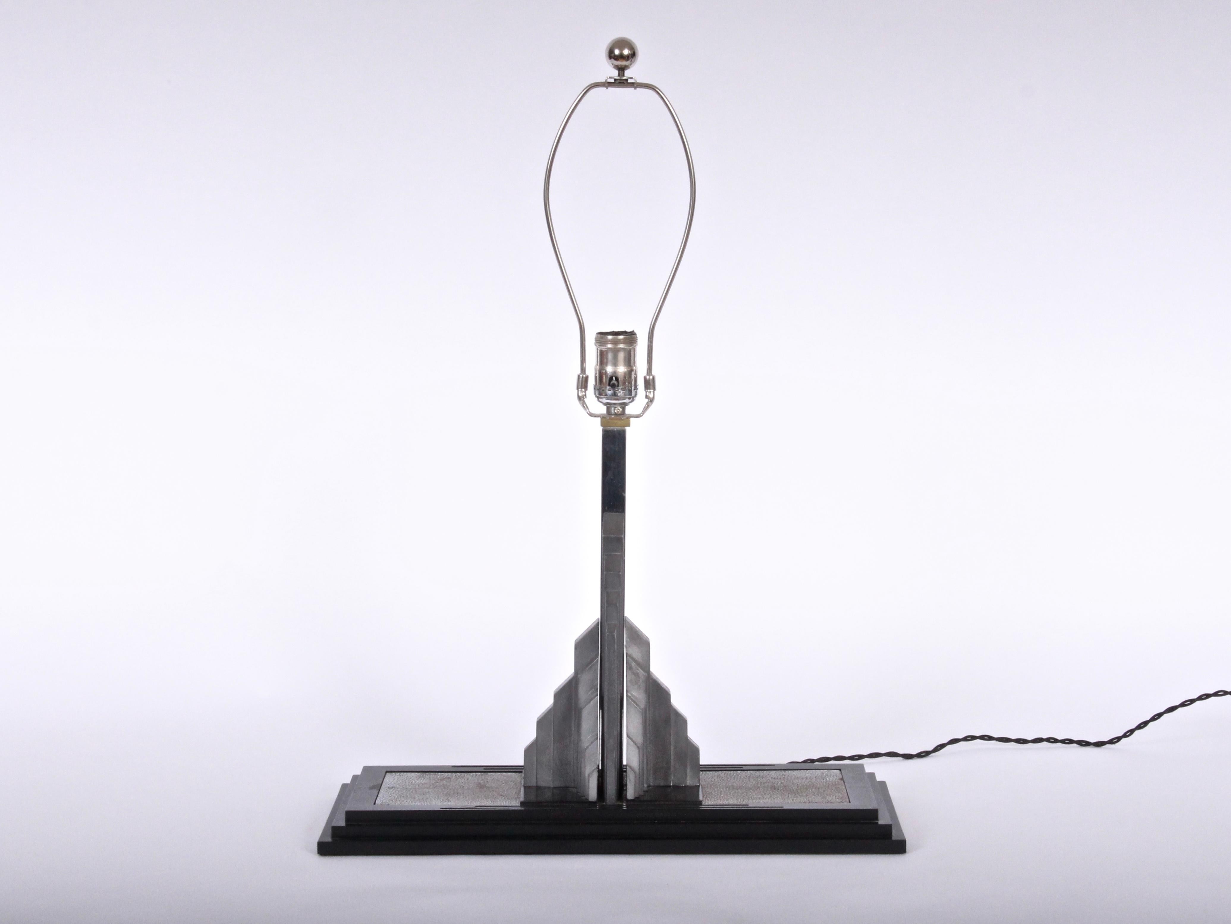 Art Deco Lib-O-Lite Skyscraper Combination Bookend Table Lamp in Cast Aluminum, Nickel-Plate and Black Bakelite for Manufacturers Finishing Company. Spring loaded Aluminum Skyscraper form, rectangular Bakelite step base with Nickel-Plated Brass