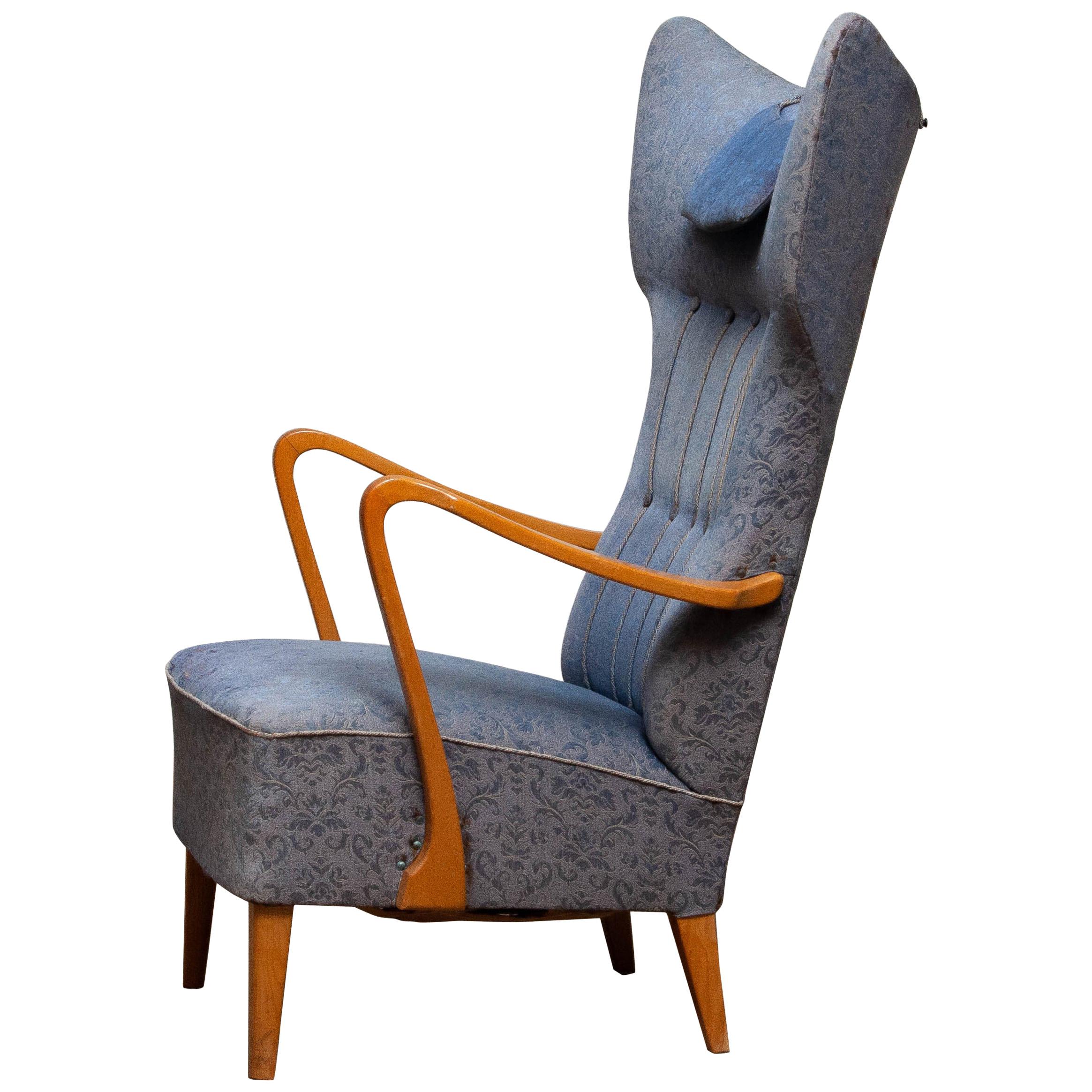 Beautiful extravagant and unique Art Nouveau wingback chair from the 1920s with extra high backrest. Made in Sweden.
The extremely slim and typical Art Nouveau armrests are made of oak in A-1 quality even as the legs.
Springs and bindings are in