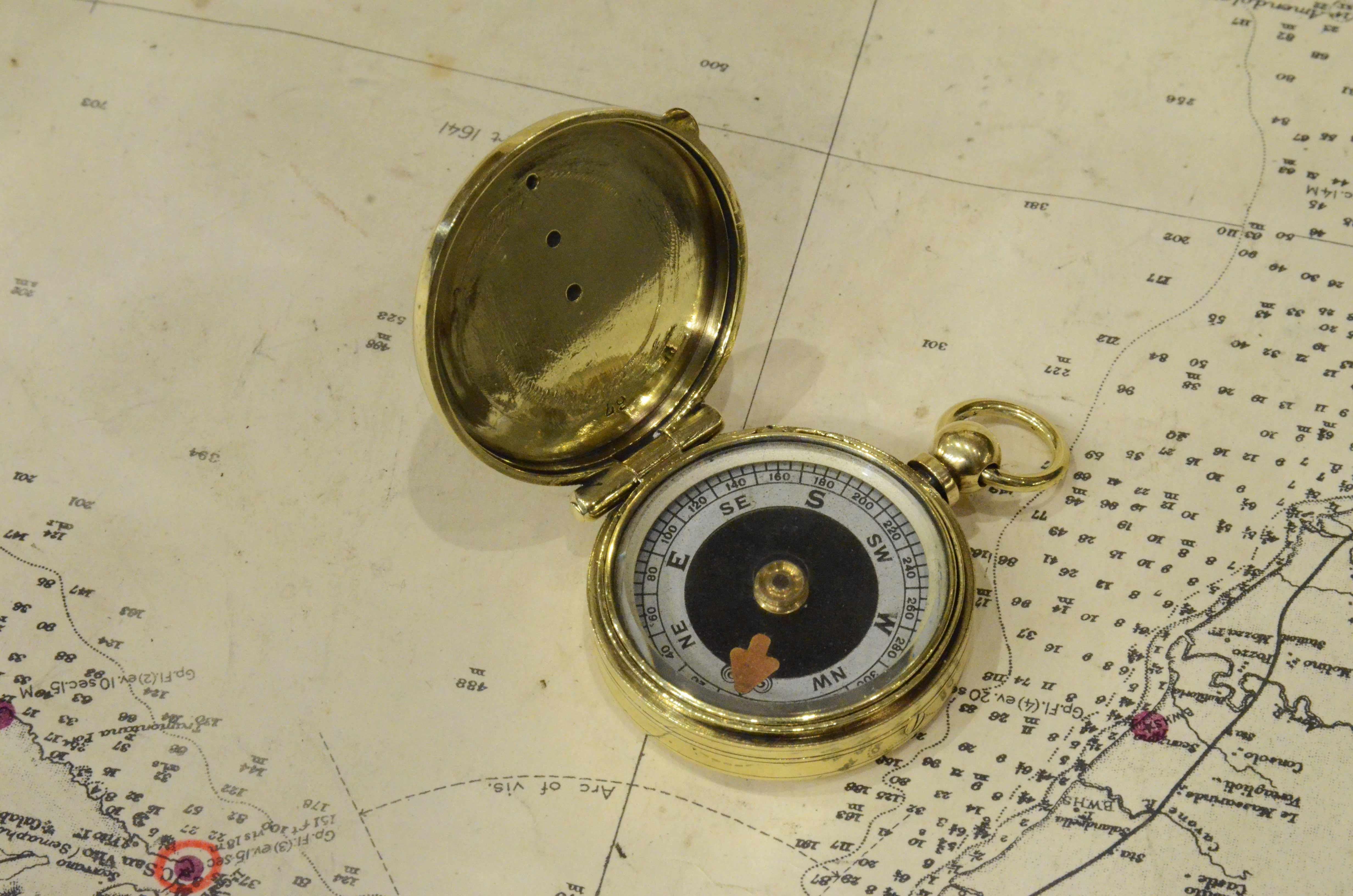 Small brass nautical pocket compass complete with cover and ring for the chain. 
Rose with eight winds complete with protractor circle for calculating horizontal angles. 
English manufacture from the 1920s. 
Very good condition, fully functional.