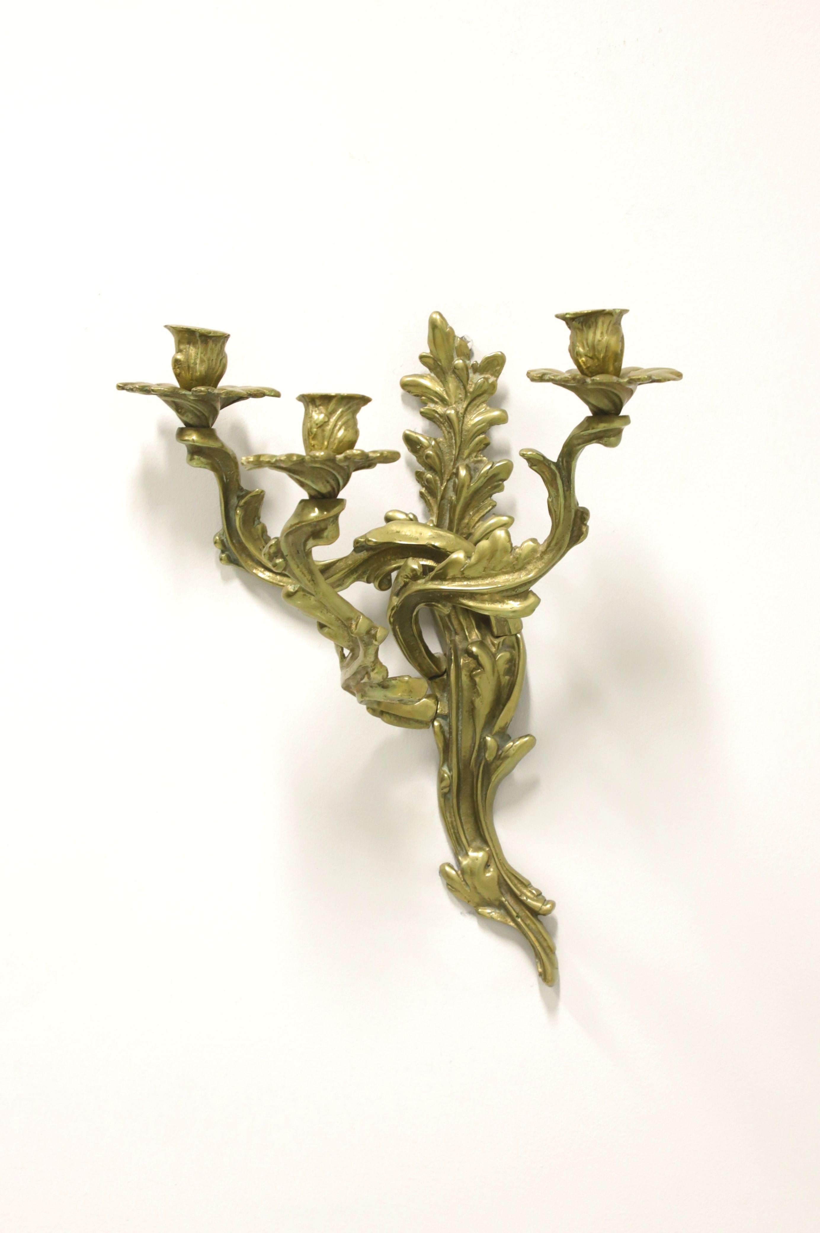 An antique Rococo style candle wall sconce, unbranded. Solid brass decoratively sculpted in a leaves & branches form, with three arms and candleholders. Possibly made in the USA, circa 1920's.

Measures: 13 W 9 D 15.5 H, Weighs Approximately: 6 lbs