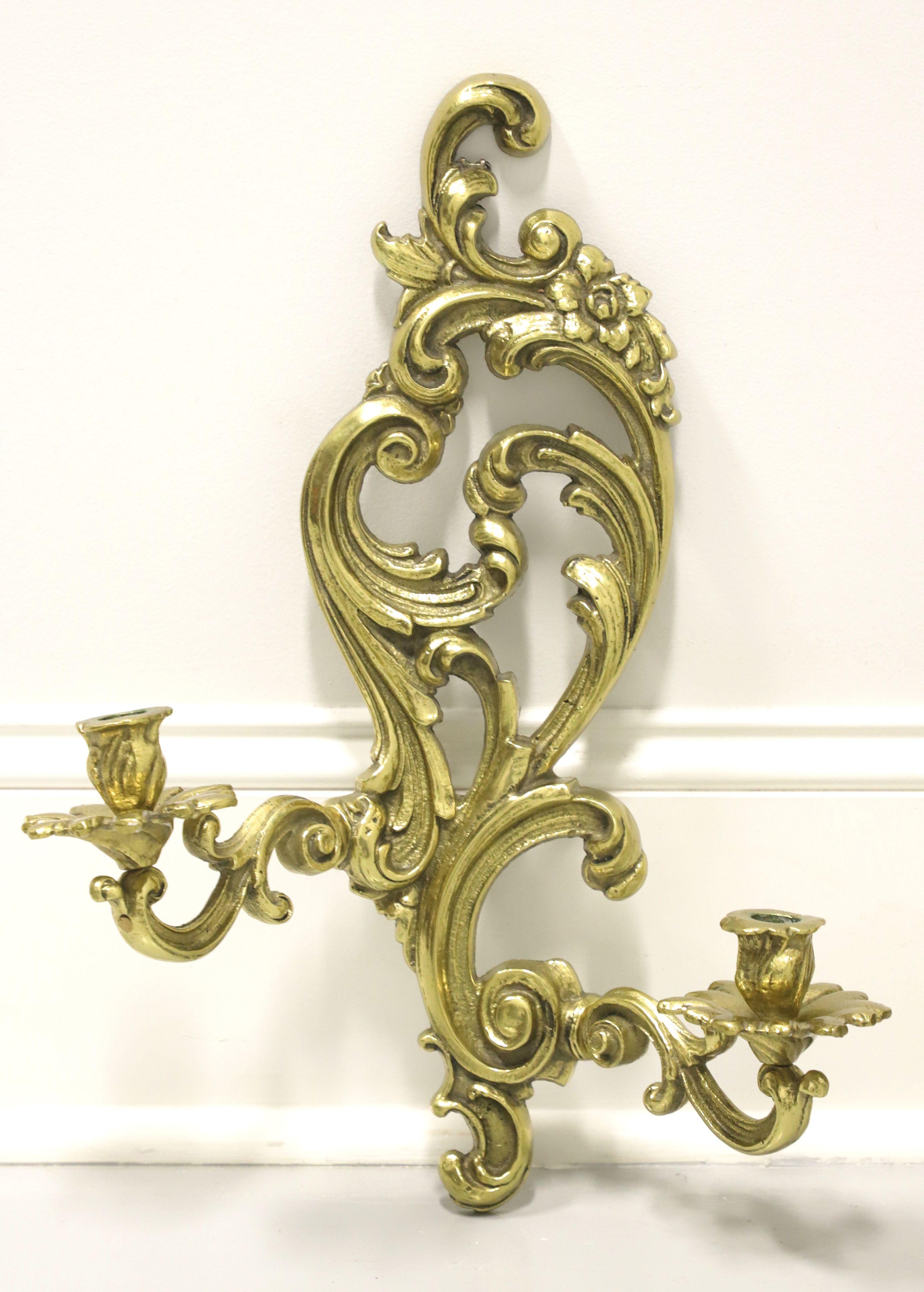 A pair of antique Rococo style candle wall sconces, unbranded. Solid brass decoratively sculpted in a swirl & botanical form, with two arms and candleholders. Possibly made in the USA, circa 1920's.

Measures: 13.5 W 5.5 D 17.5 H, Weighs