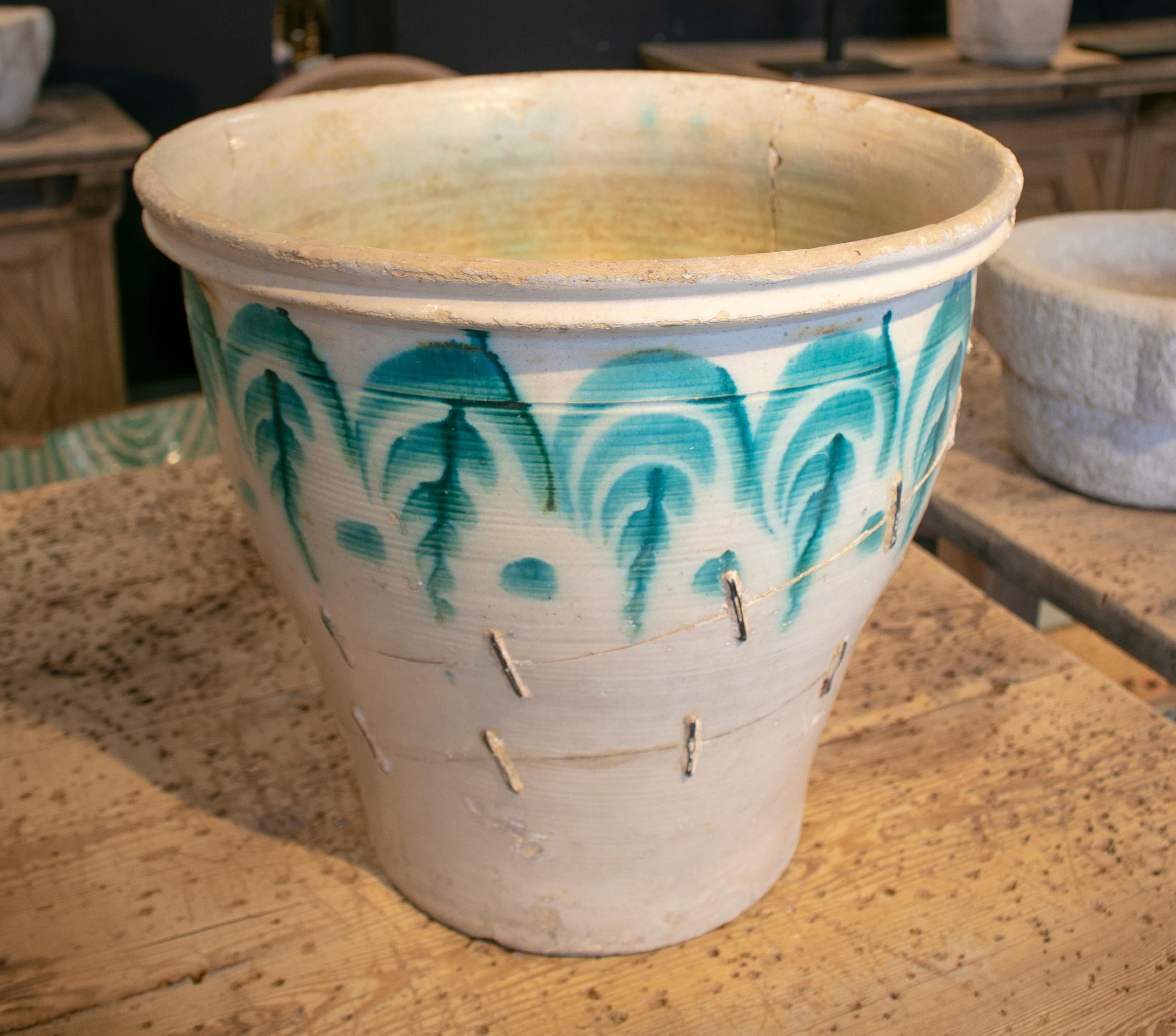 1920s Spanish Granada white and green glazed ceramic pot with iron staples.