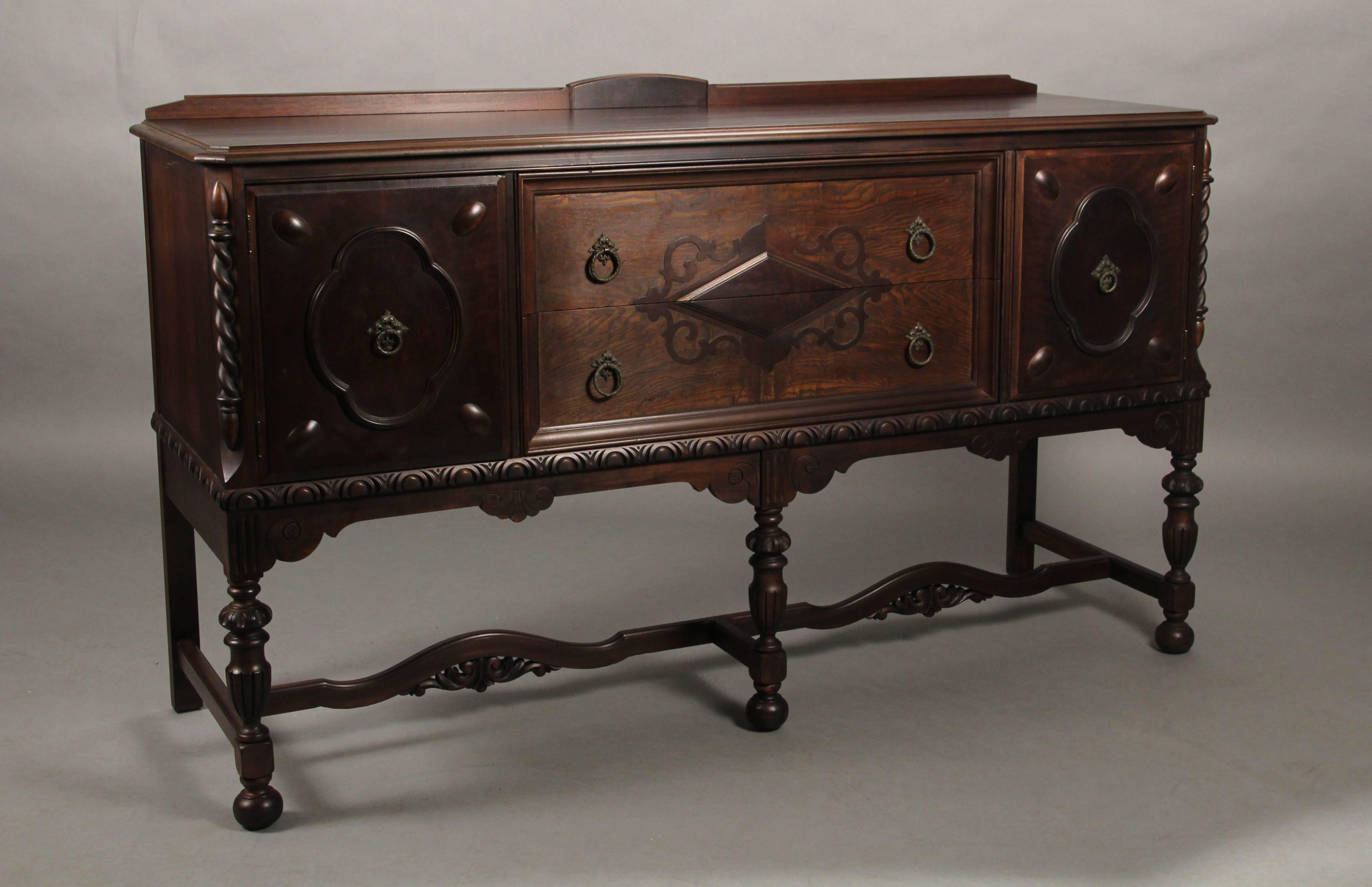 Attractive 1920s carved walnut sideboard with two drawers and two doors. Measures: 39.25