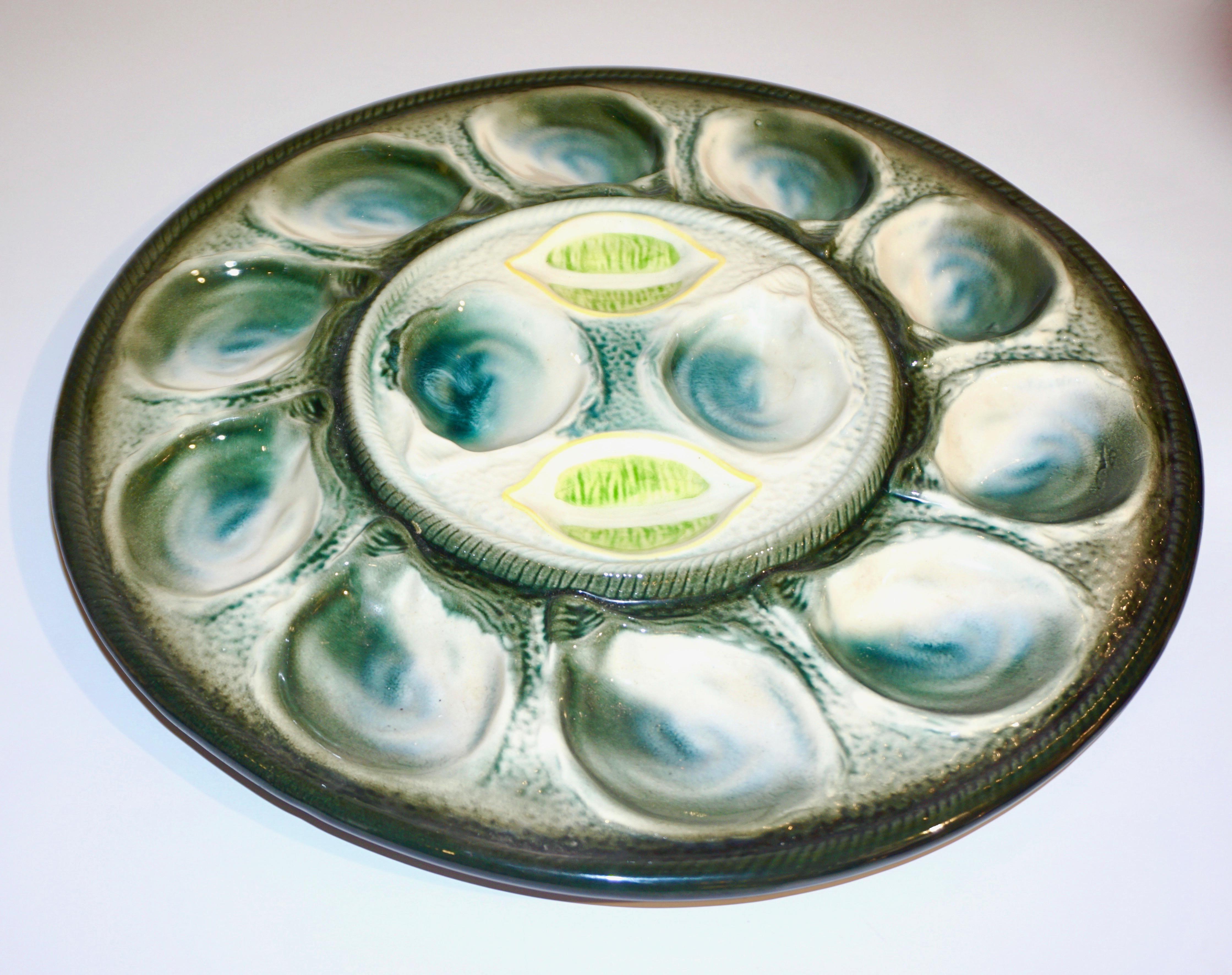 1920s French Art Deco Majolica set of 6 oyster dishes complete with a serving platter for 12 oysters and lemon halves. A set signed by St. Clement Frères, a factory with a very old tradition in 
