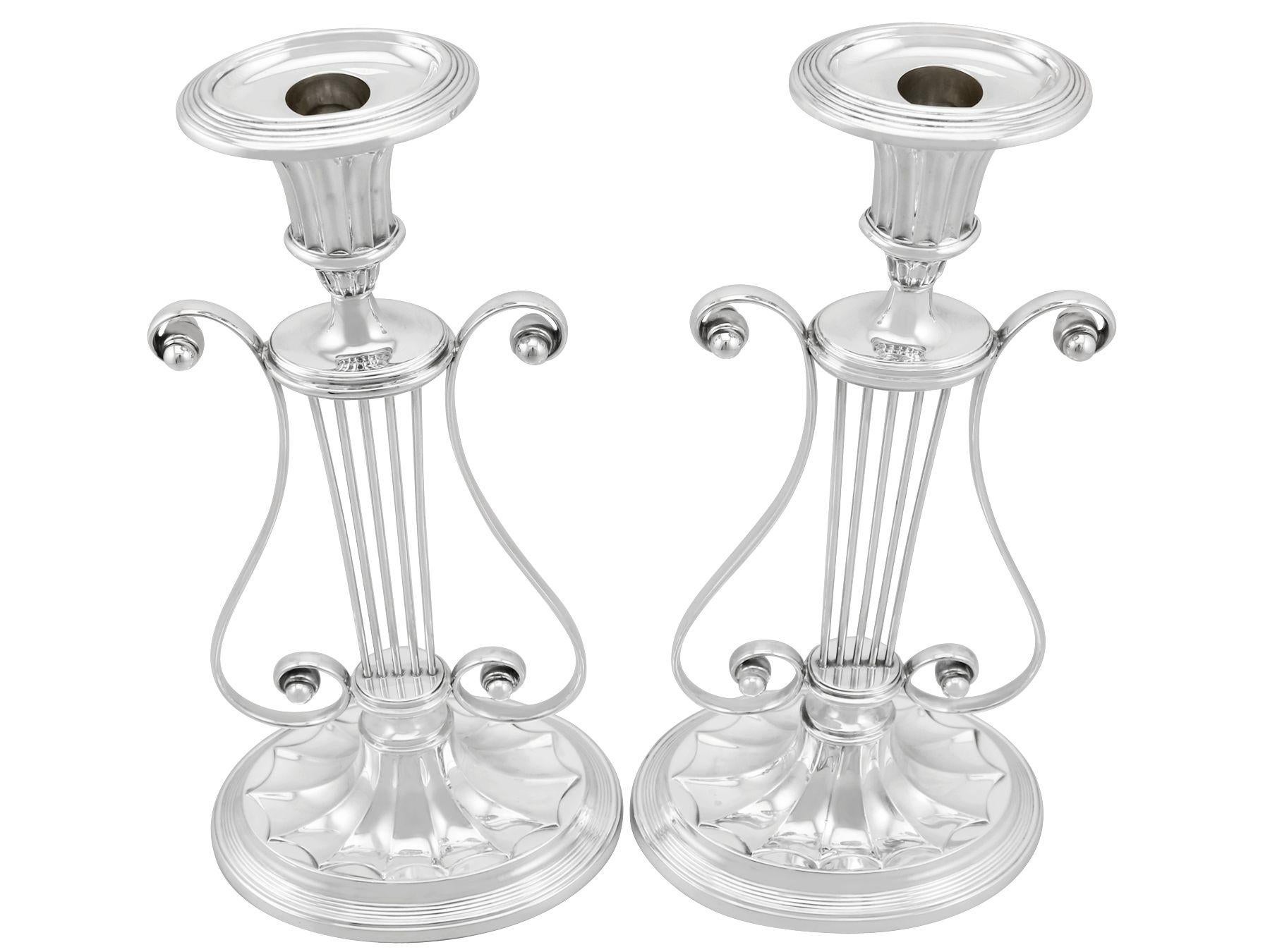 An exceptional, fine and impressive, rare pair of large antique George V English sterling silver lyre candlesticks; an addition of our ornamental silverware collection.

These exceptional antique George V English sterling silver candlesticks have