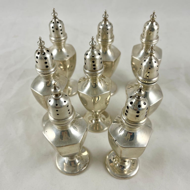 A set of eight salt and pepper shakers, sterling silver, marked: P.H. Locklin, NY, NY, circa 1920s.

Pairs of tall paneled shakers, footed and capped – four each salt and pepper. Pierced caps are sized with larger holes for salt, smaller for