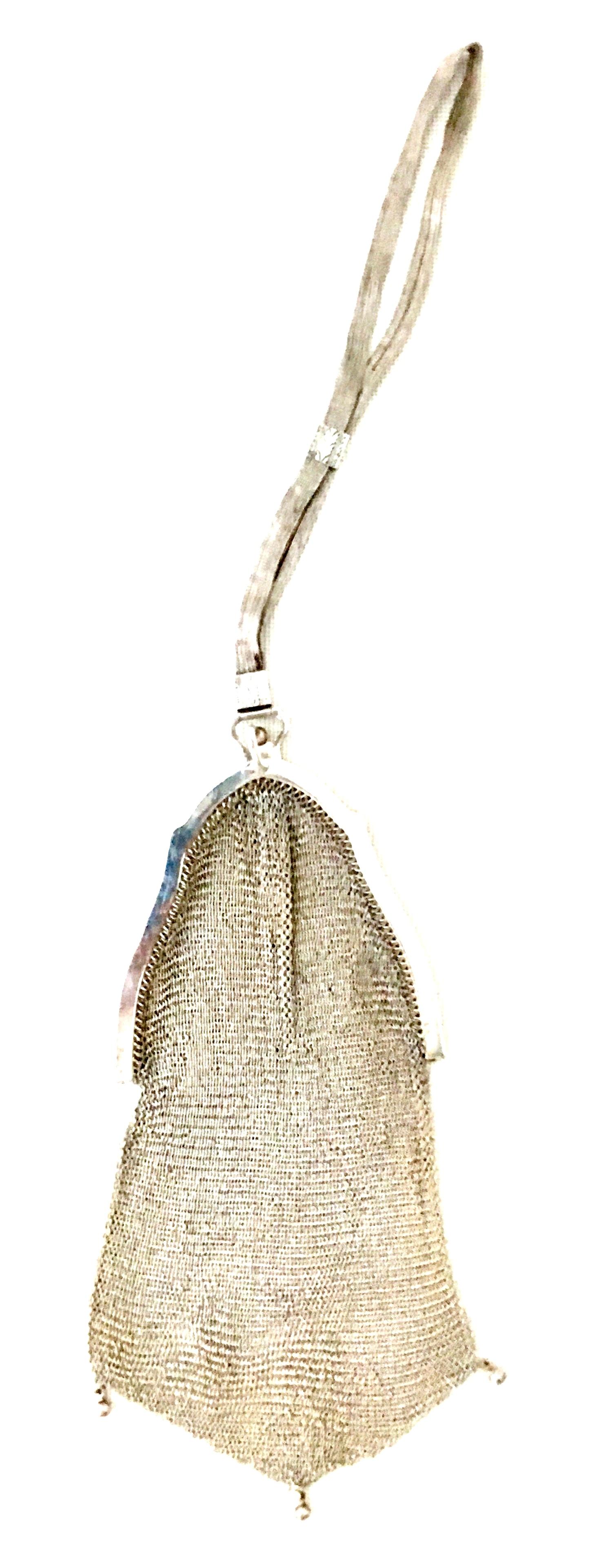 Antique Whiting & Davis Sterling Silver Soldered Ring Mesh Flapper Wristlet Style Hand Bag. This rare Art Nouveau evening bag features, sterling silver ring style soldered mesh, etched Art Nouveau motif frame with snap through closure. The 
