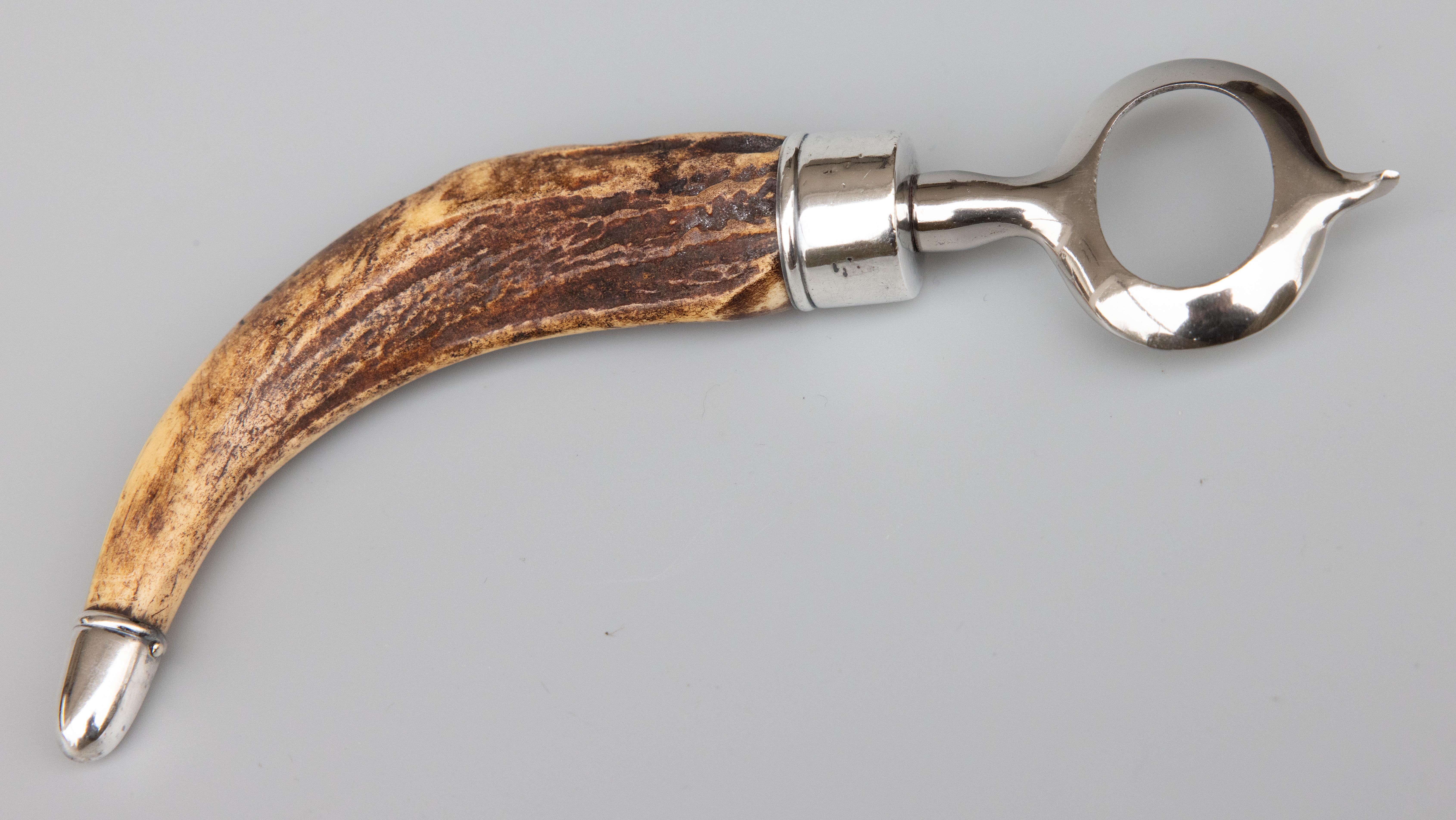 A fine antique sterling and stag horn handle bottle opener, circa 1920. Marked 