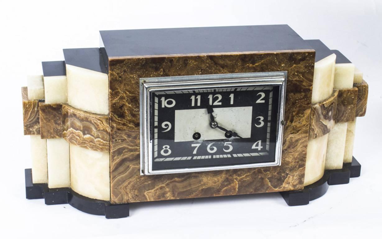 An exquisite original antique marble Art Deco mantle clock with a pair of garnitures, circa 1920 in date.
 
The case of the clock is made from contrasting specimen marble with a black and chrome rectangular dial and comes with a matching pair of