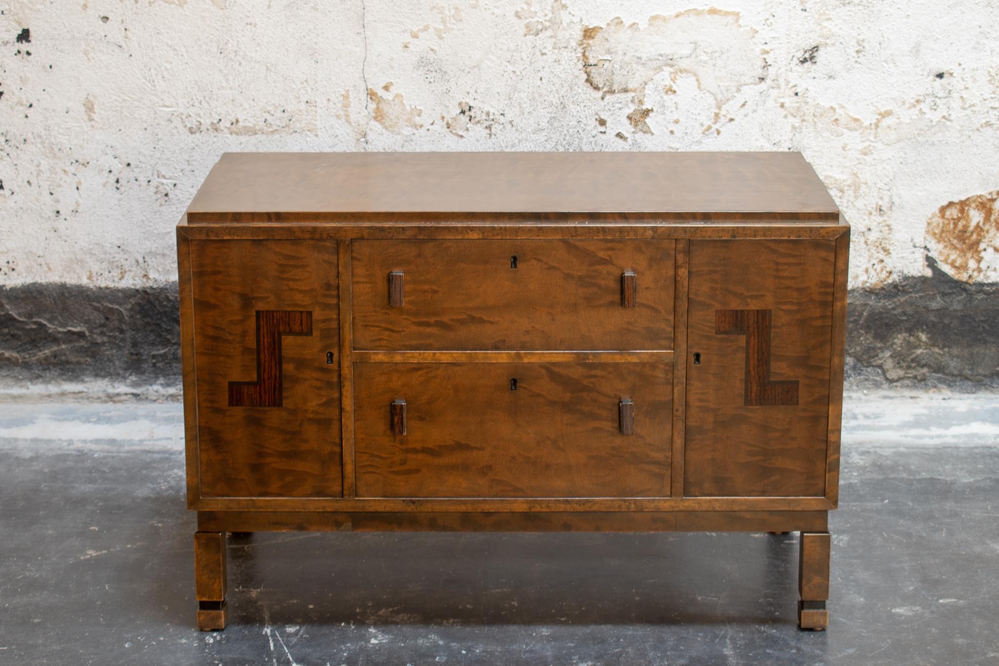 Antique Swedish Art Deco chest with rosewood inlay. This versatile piece features two deep drawers, two cabinet doors, with a shelf in the right cabinet. Original key included.