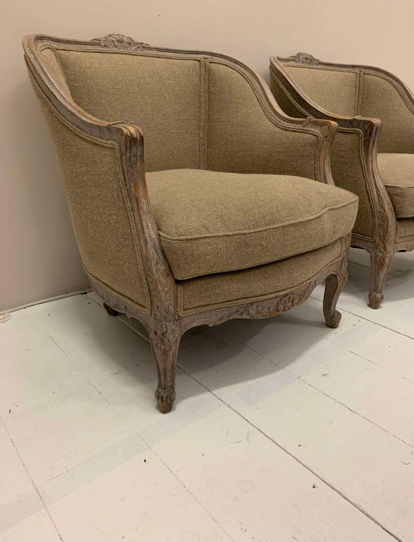 Un par de hermosos sillones suecos de generosas dimensiones de hacia 1920  al gusto francés.
El marco de madera clara lavada conserva restos de la pintura original y hay detalles decorativos en la parte central trasera.
Las sillas son profundas y