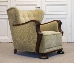 1920s Swedish Wingback Chair With Golden Velvet And Carved Oak Armrests