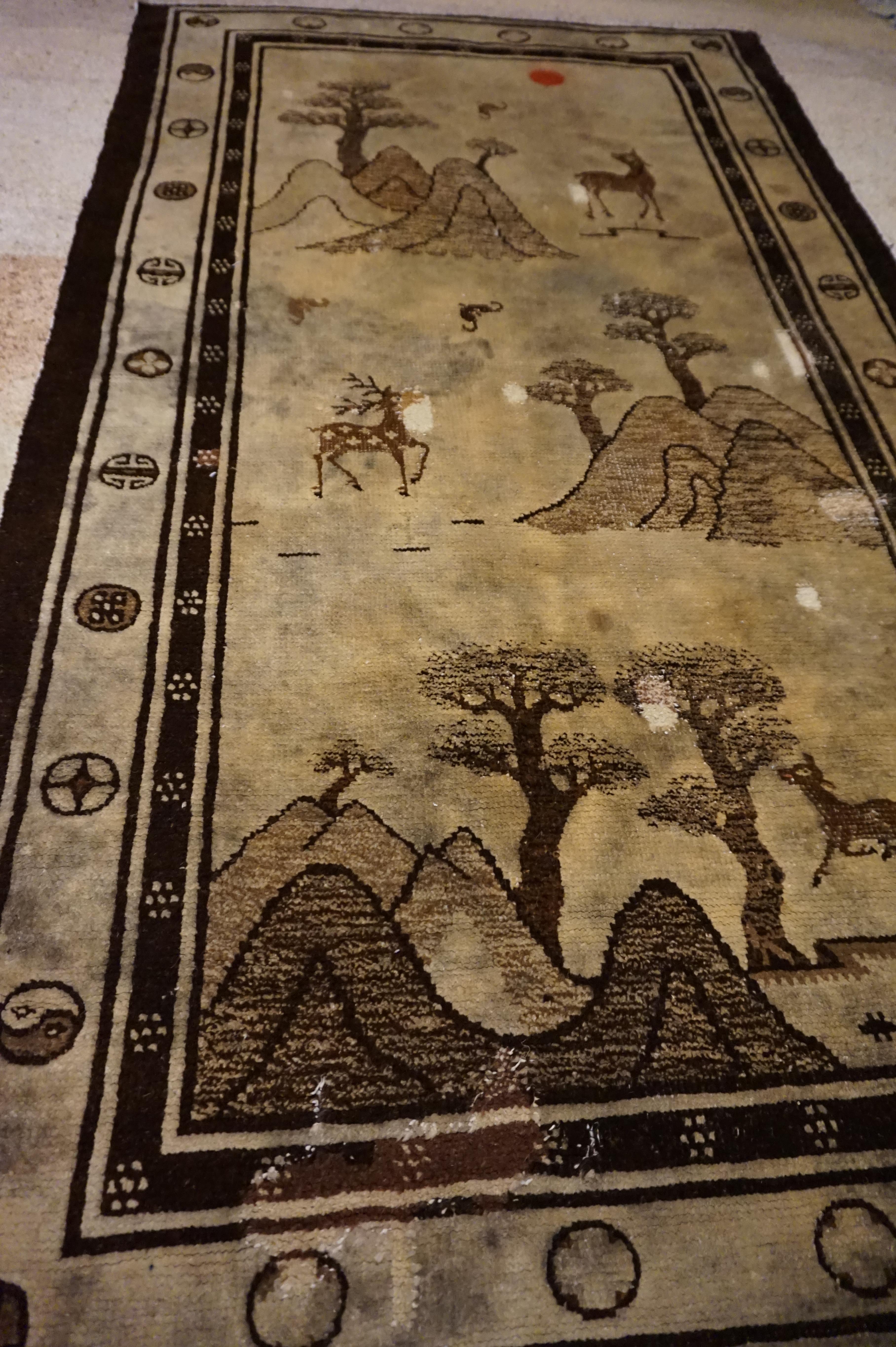 Rare hand knotted rug from Tibet depicting deer in various seasons. Some repair work and imperfections as visible in the rug (photos) but nonetheless a unique piece in sepia tones,

circa 1920s.