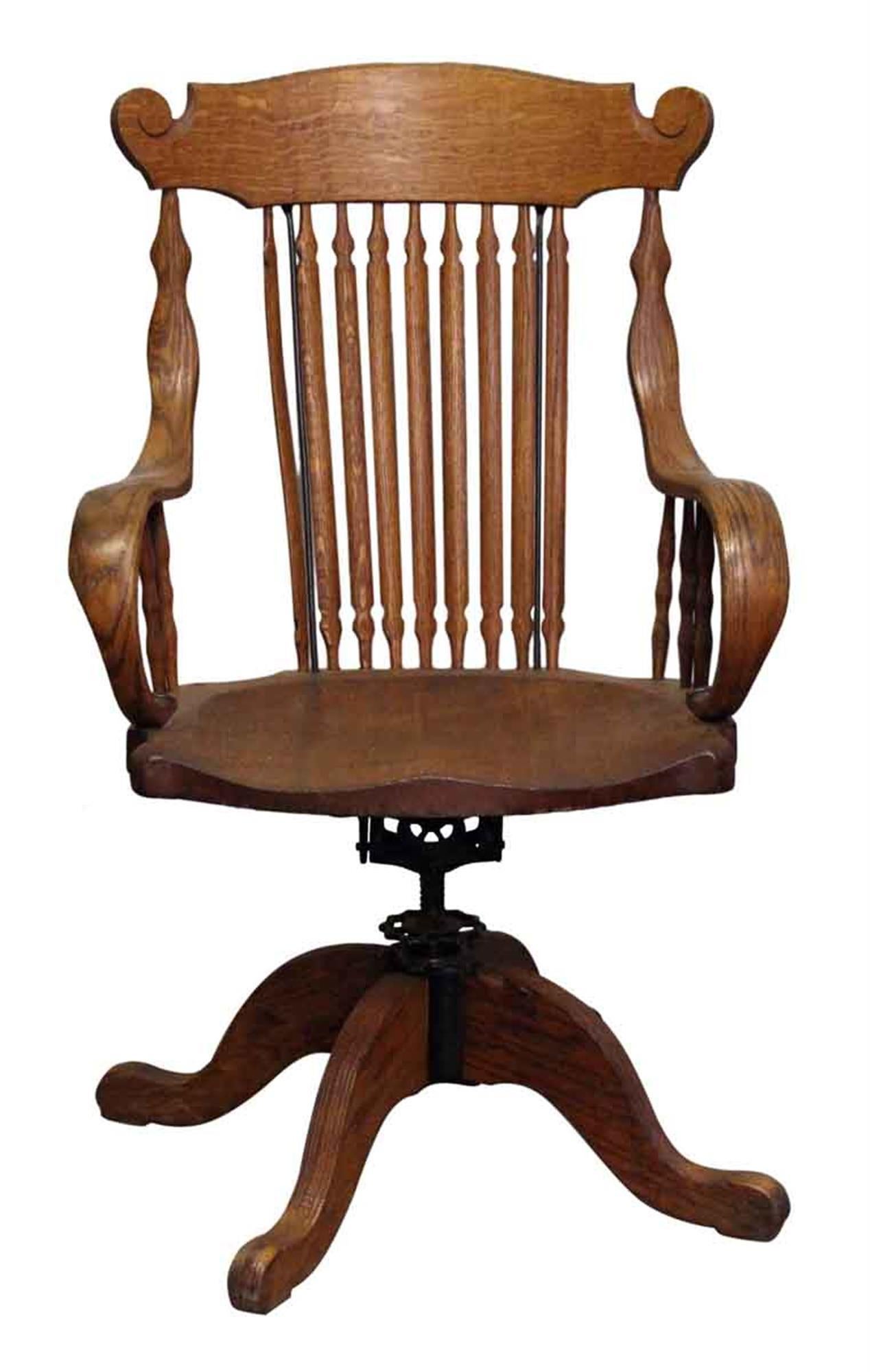 1920s beautifully carved tiger oak chair with a finely crafted spindle back and bentwood arms. This can be seen at our 302 Bowery location in Manhattan.