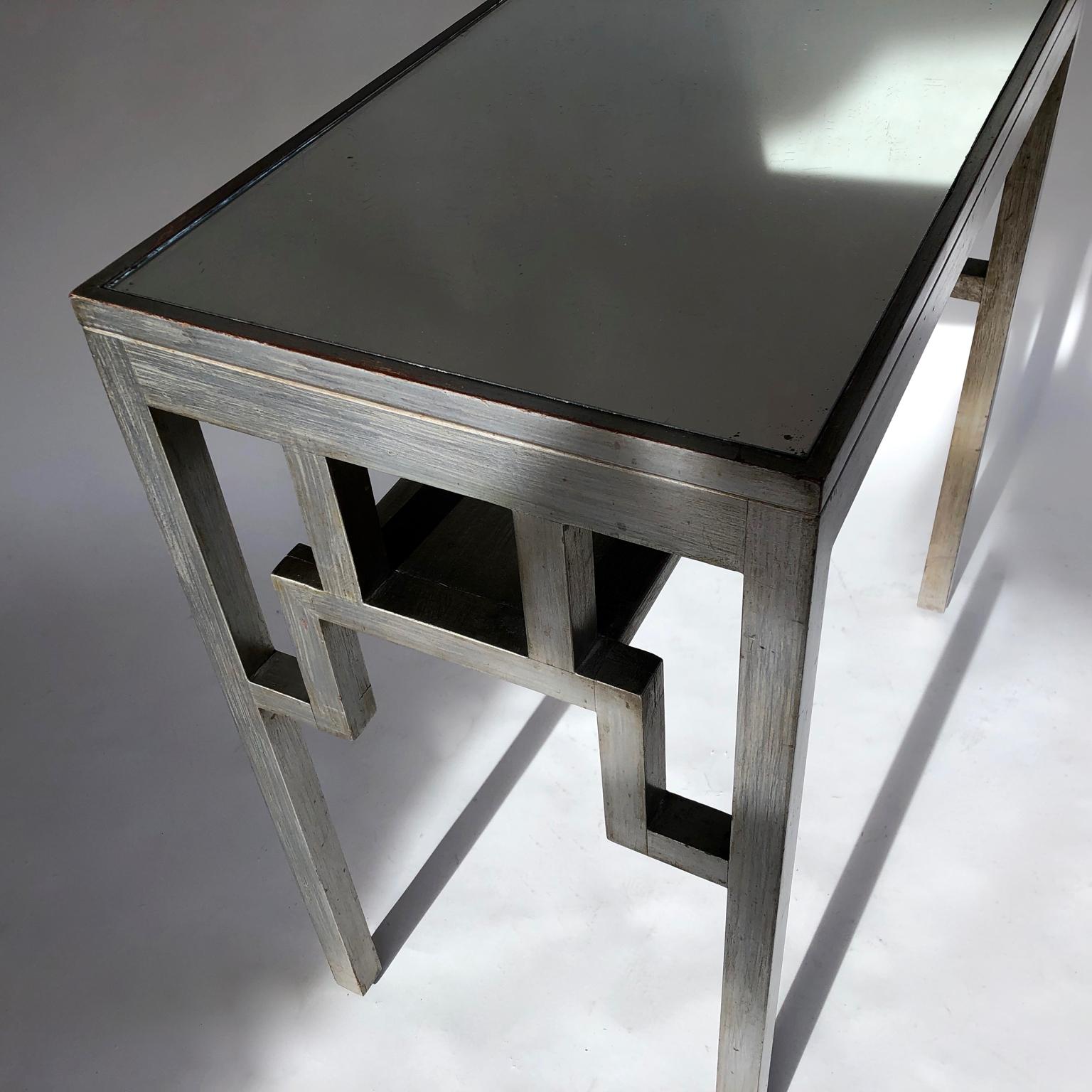 Rare 1920s to 1940s Japanesque silvered wooden console, table, vanity or small desk by Rowley, London. Mirrored top with small shelf underneath. Rowley label. Beautifully worn modernist look, typical of the Rowley Gallery furniture of the period.