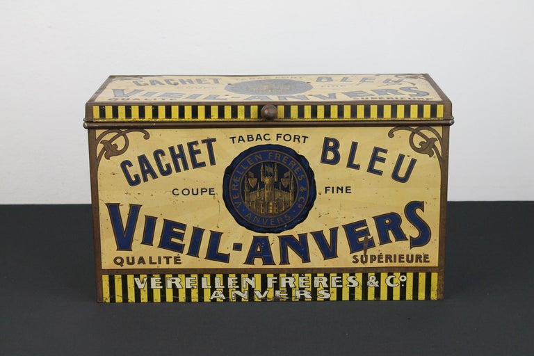 Antique tobacco tin from the 1920s.
An Early 20th century large tobacco tin, tobacco box, tobacco storage box made of metal.
This antique lithographic shop tin for tobacco 
was made and designed for the Belgian company Verellen Frères and Co