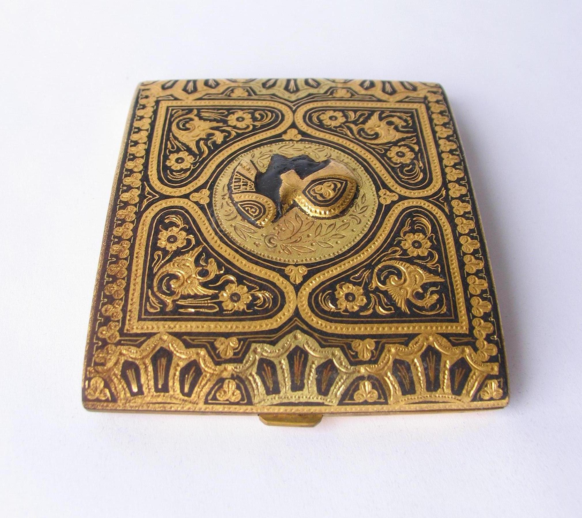 Gold inlaid Toledo damascened cigarette case circa 1920s. Exquisitely detailed Fine metalwork, crafted in brass, 22-karat gold and oxidized steel, in excellent condition.

The damascene process involves etching the design lightly with a