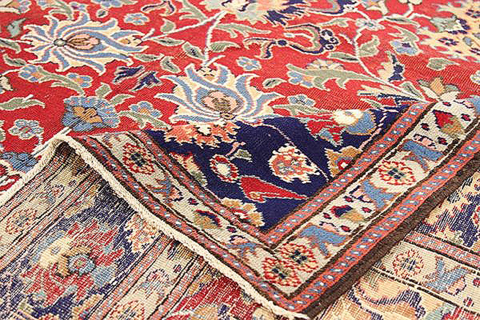 Antique Turkish rug handwoven from the finest sheep’s wool and colored with all-natural vegetable dyes that are safe for humans and pets. It’s a traditional Sivas design featuring all-over rows of floral details in beige, gray, and navy over a red