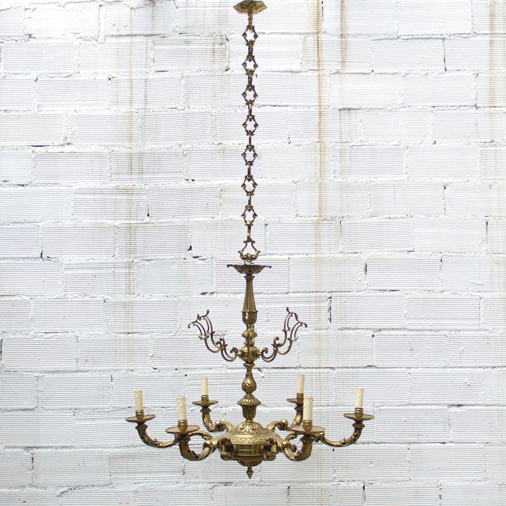 Baroque chandelier, solid bronze, gold color, 1920s.

An impressive 1920s bronze chandelier with 6 ornate arms. This chandelier is made of solid bronze, finished in both a brushed and polished look. There are 6 lightbulb arms made with scrolling