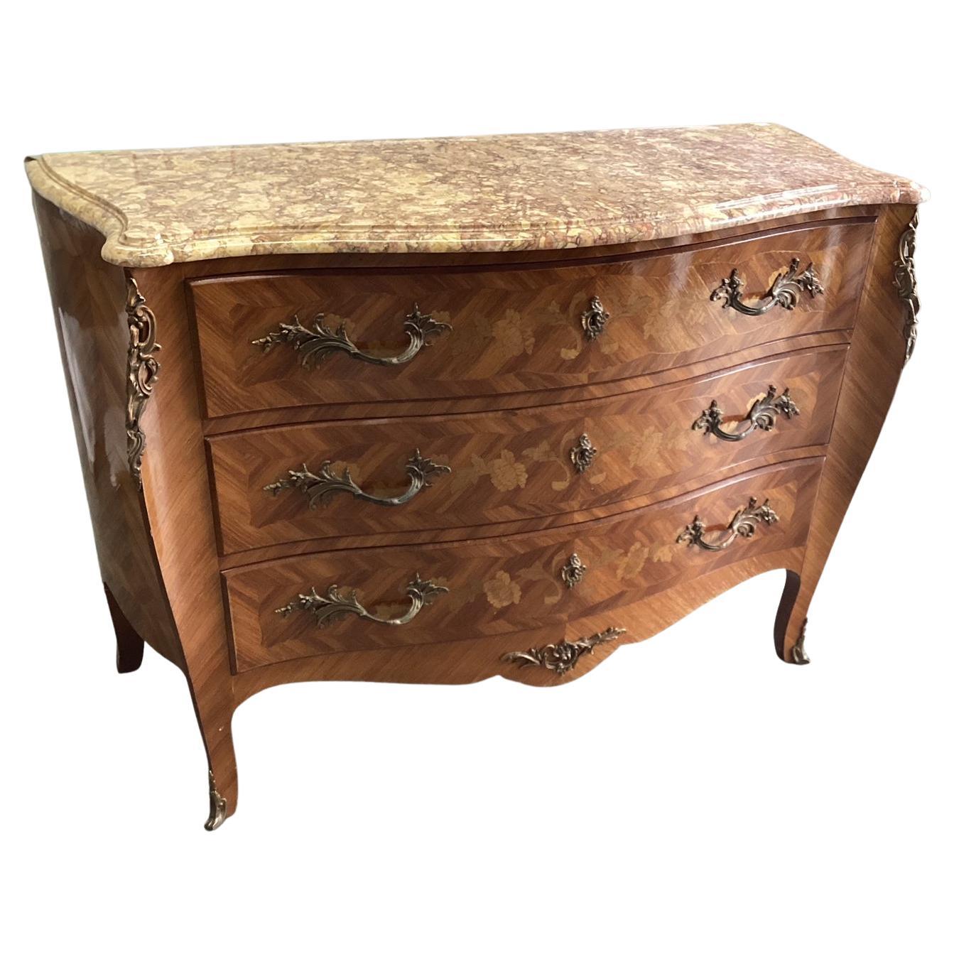 Beautiful Louis XV bombe chest of drawers with satinwood inlay. Made in France in the 1920's this chest features 3 wide drawers and a stunning pink marble top. The marble is beveled and the corners are rounded for added elegance. This chest features