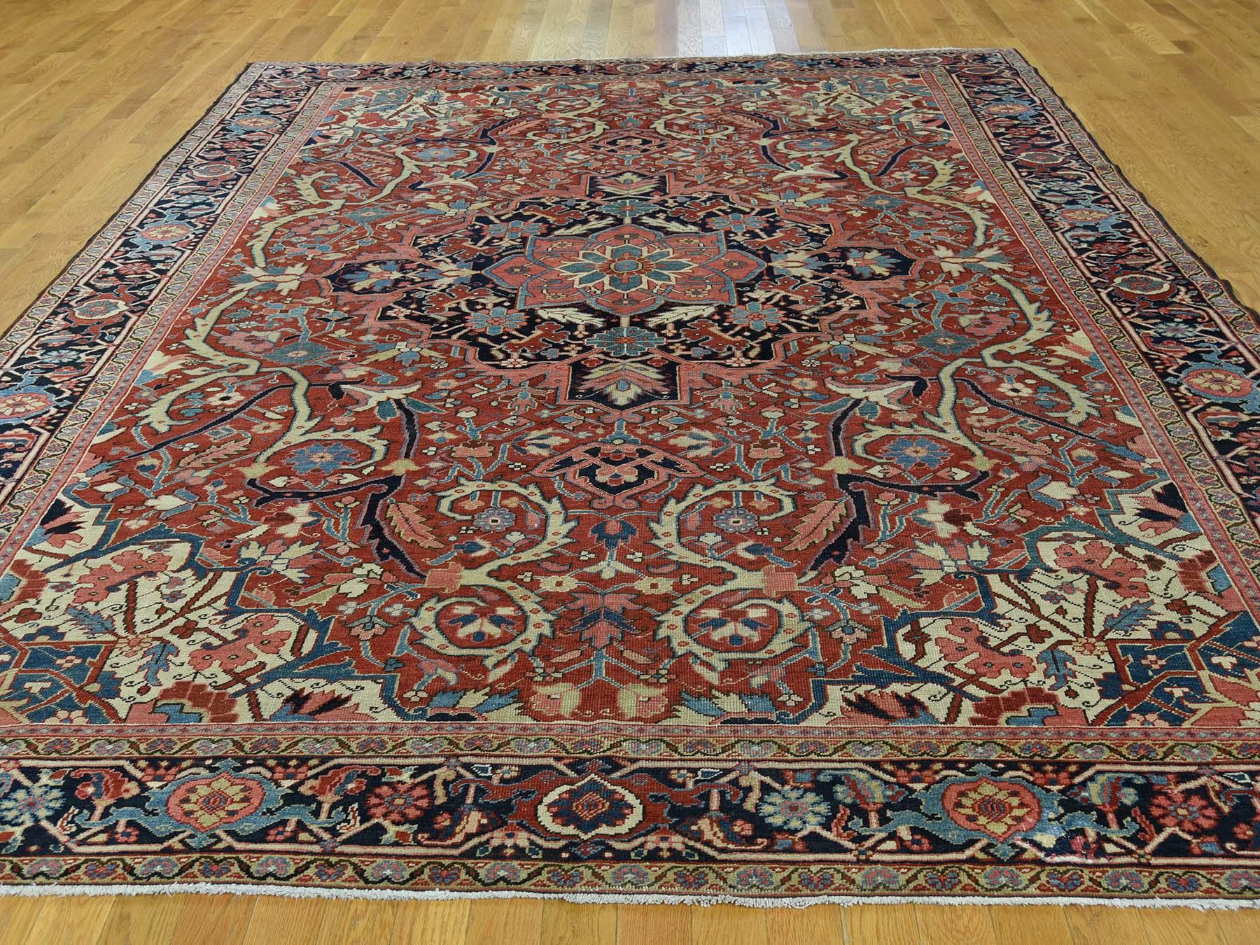 This is a genuine hand knotted oriental rug. It is not hand tufted or machine made rug. Our entire inventory is made of either hand knotted or handwoven rugs.

Remake your home with this amazing antique carpet. This handcrafted Persian Heriz