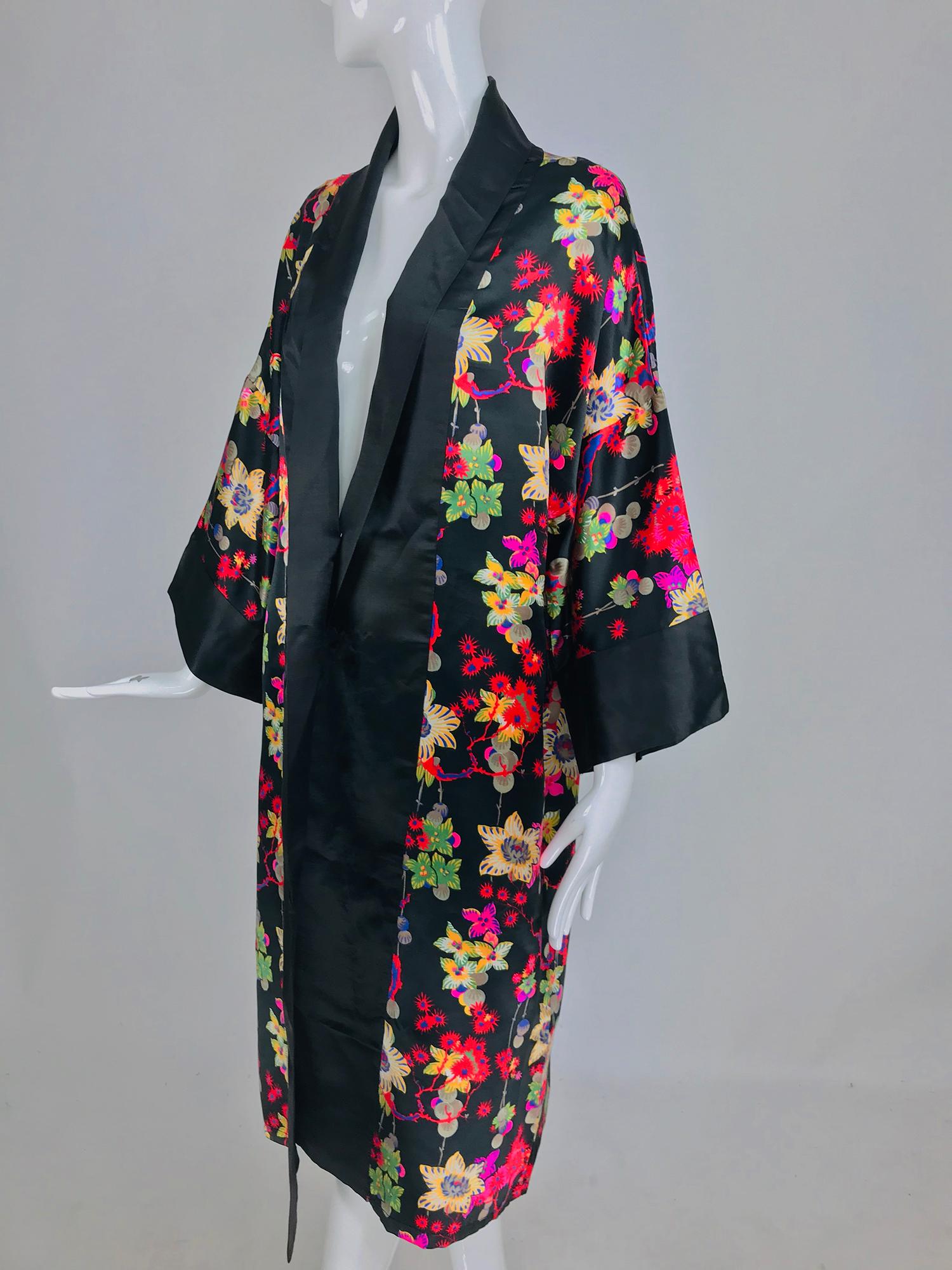 1920s vintage silk kimono robe fantasy floral print. This beautiful robe has the most amazing print, the colours are vivid and pop against the black ground, the flowers are like fireworks and some of them look like they are sprouting little