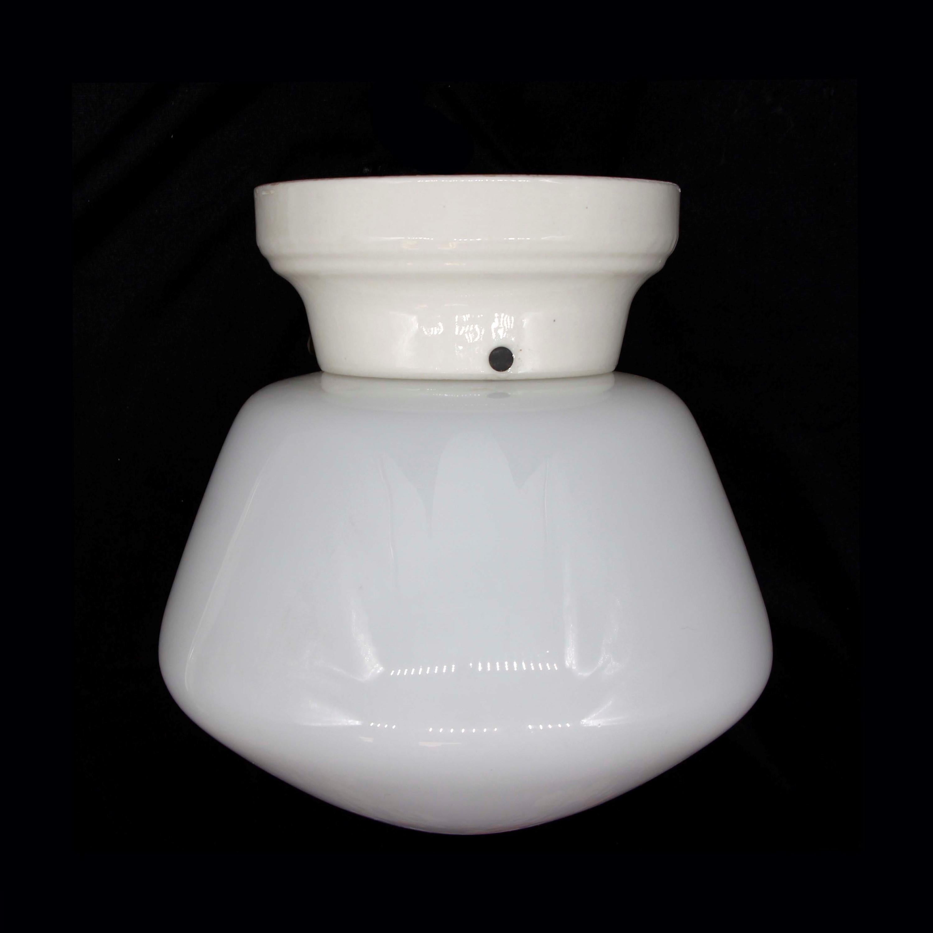 1920s Flush mount bathroom or kitchen light with a white ceramic base and schoolhouse glass globe. The price includes restoration. Small quantity available at time of posting. Priced each. Please inquire. Please note, this item is located in our
