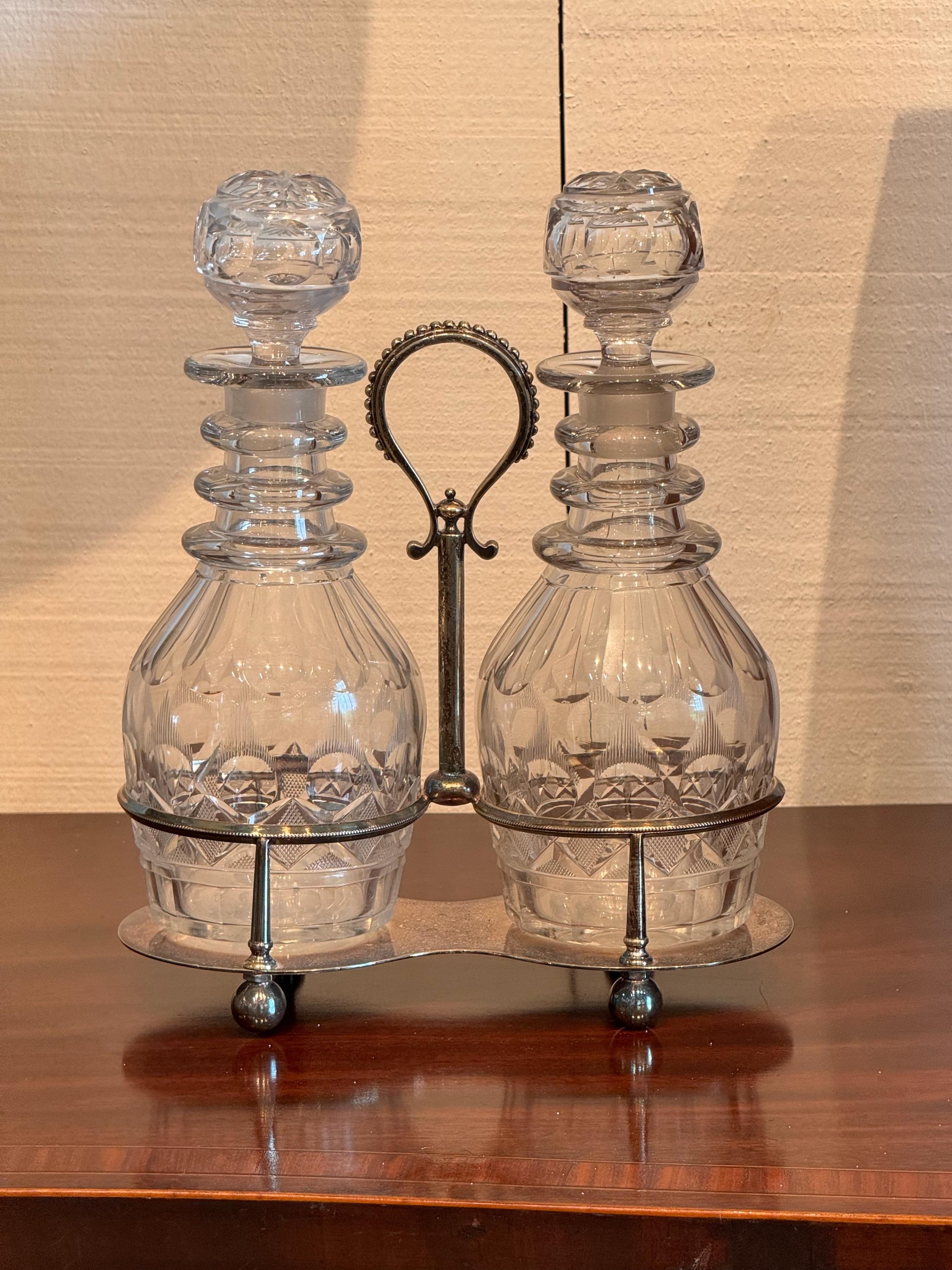 A nice pair of decanters. With silver plate holder.
