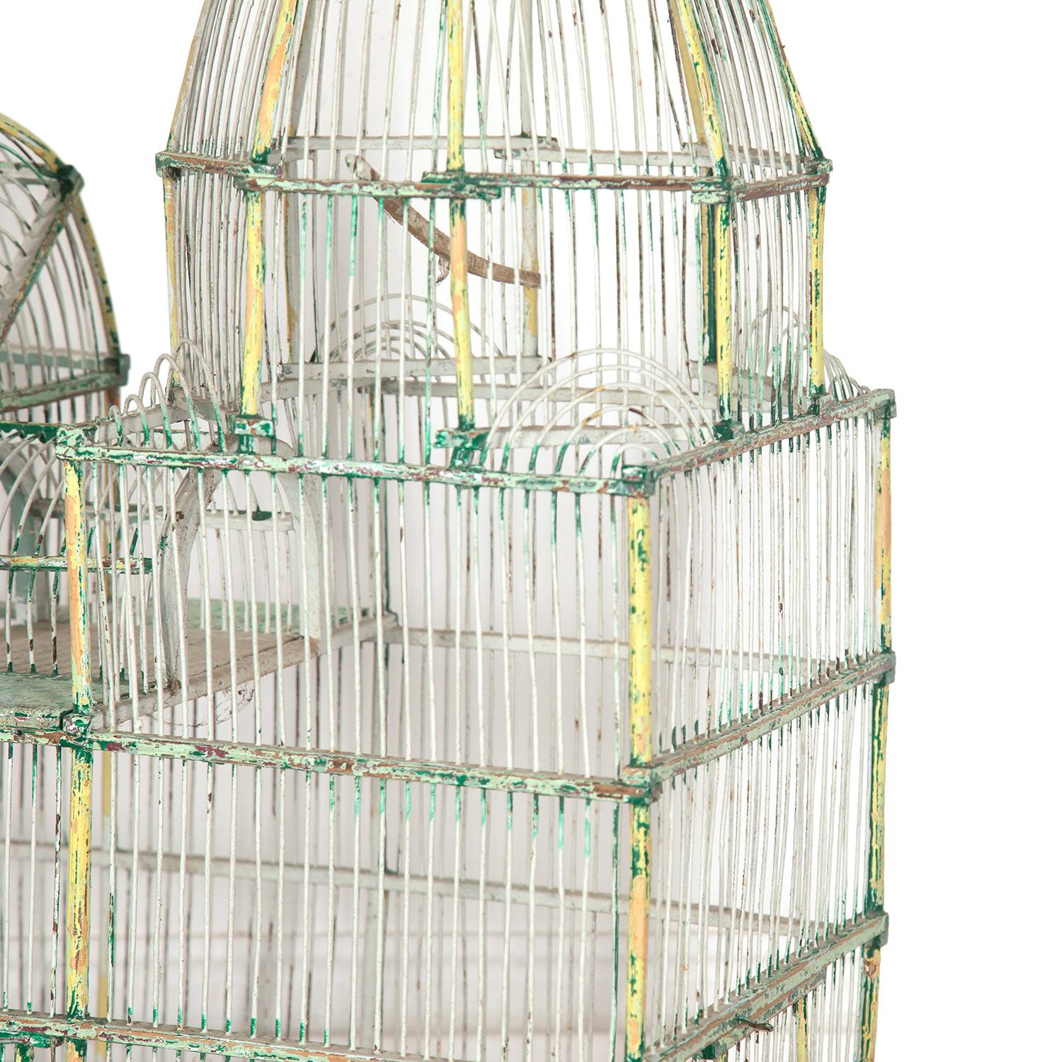 Very decorative French 1920s bird cage. 

This large bird cage has a domed design, emulating a grand piece of architecture. It comprises an elaborate wirework structure, with original zinc liners and feeders. 

Resting on a wooden base, this