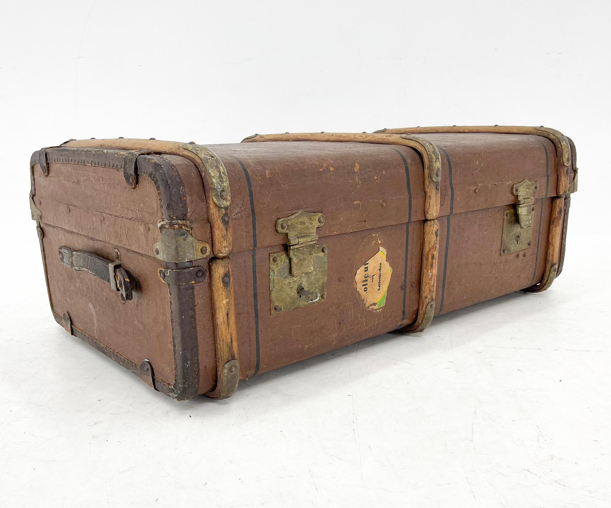 Antique travel case with wooden straps, original locks with one working key to both locks. The handles and side edges of the case are leather. There is metal hardware on the wooden straps and monograms on the top. The suitcase is suitable for the