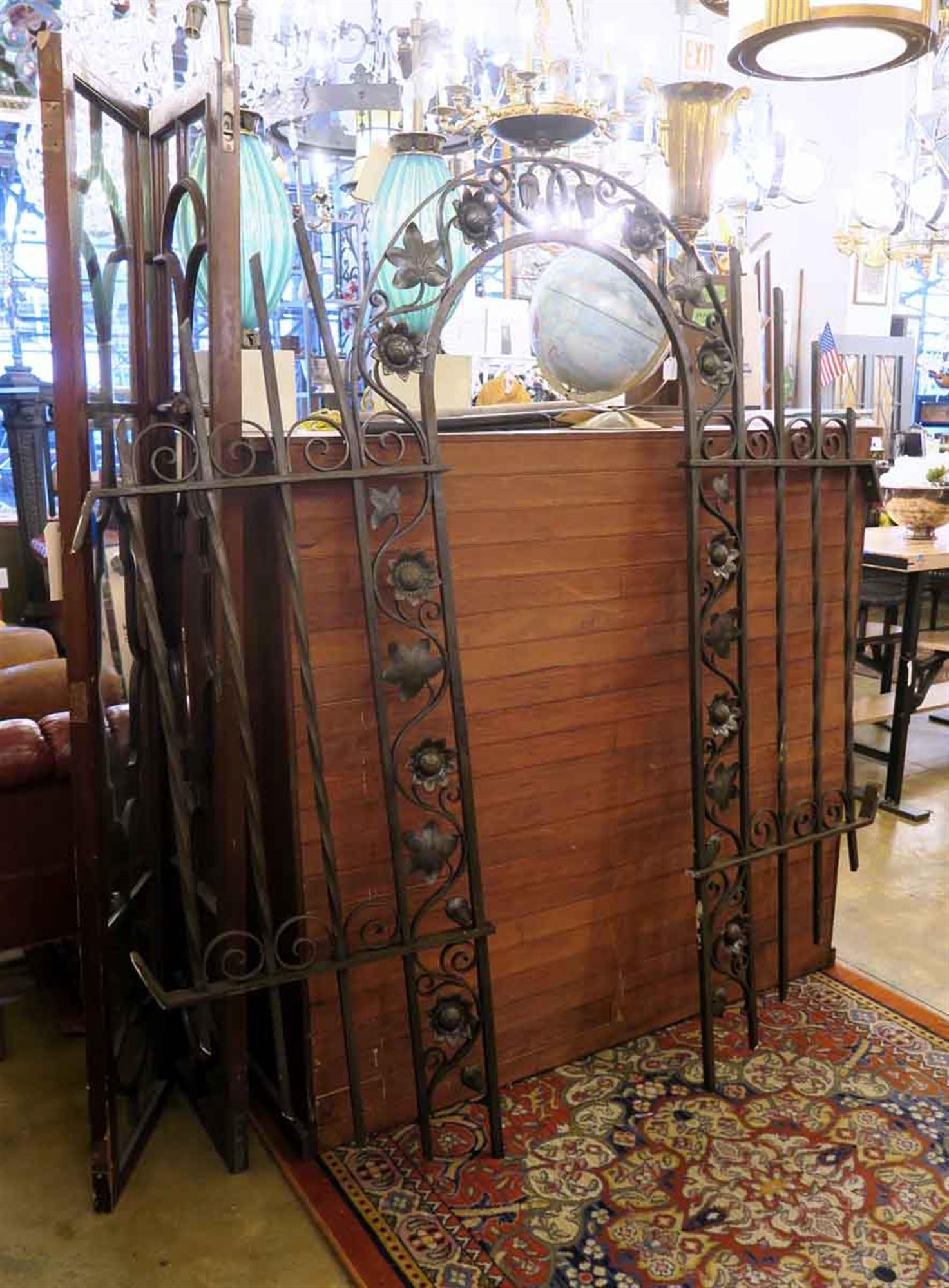 1920s cast and wrought iron gateway arch with Art Nouveau details and a black finish. This can be seen at our 2420 Broadway location on the upper west side in Manhattan.