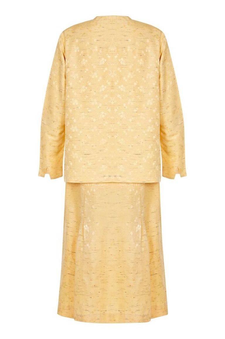 This lovely 1920s silk flapper dress with matching jacket is in extrodinary condition for the era. The pure silk fabric in soft yellow cream is subtly embossed with a delicate dandelion design and is textured with thin flecks of coloured silk thread