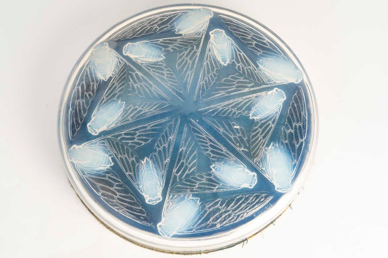 René Lalique: “Cléones” box in opalescent glass René Lalique

Model created in 1921. 

Original base made of cardboard covered with light blue silk satin.
Signature molded on the lid.


Diameter: 17 cm

Bibliography: Félix Marcilhac, René Lalique -
