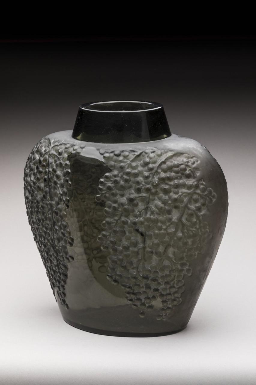 René Lalique (France, 1860–1945)

“Poivre” vase, model created in 1921
Topaz gray glass with black patina. Signed “R. Lalique.”
Height: 9.5 inches. Width: 9.7 inches. Depth: 5.7 inches.