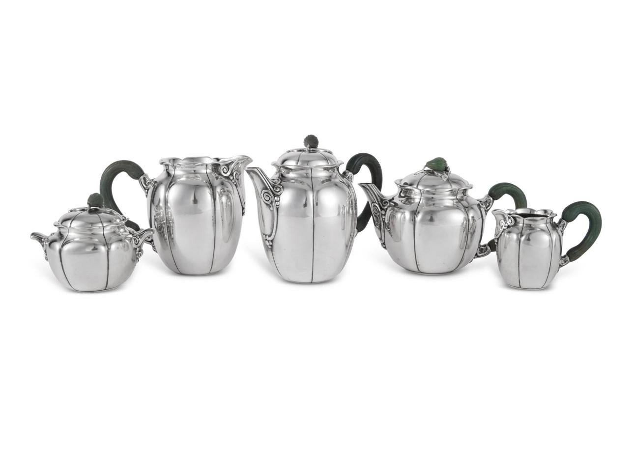Tea and coffee service in sterling pure silver and nephrite by Jean E. Puiforcat.

Service including :
- a coffee pot 15.5 cm
- a teapot 11.5 cm 
- a milk jug 12,5 cm 
- a milk jug 7 cm 
- a sugar bowl 10 cm

Minerve Solid Silver 950/1000