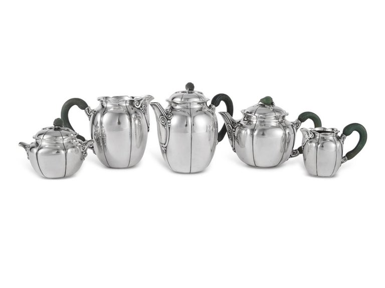 Tea and coffee service in sterling pure silver and nephrite by Jean E. Puiforcat.

Service including :
- a coffee pot 15.5 cm
- a teapot 11.5 cm 
- a milk jug 12,5 cm 
- a milk jug 7 cm 
- a sugar bowl 10 cm

Minerve Solid Silver 950/1000