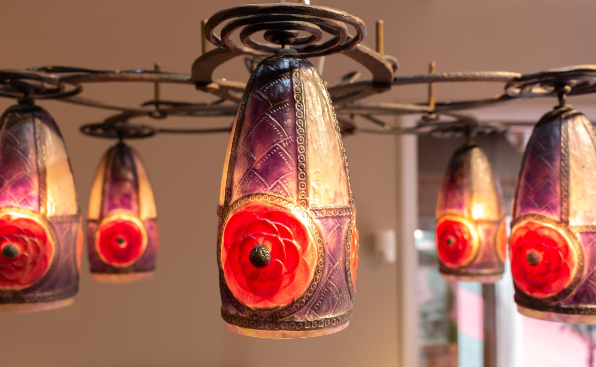 A black patina wrought iron ceiling light and seven conic 