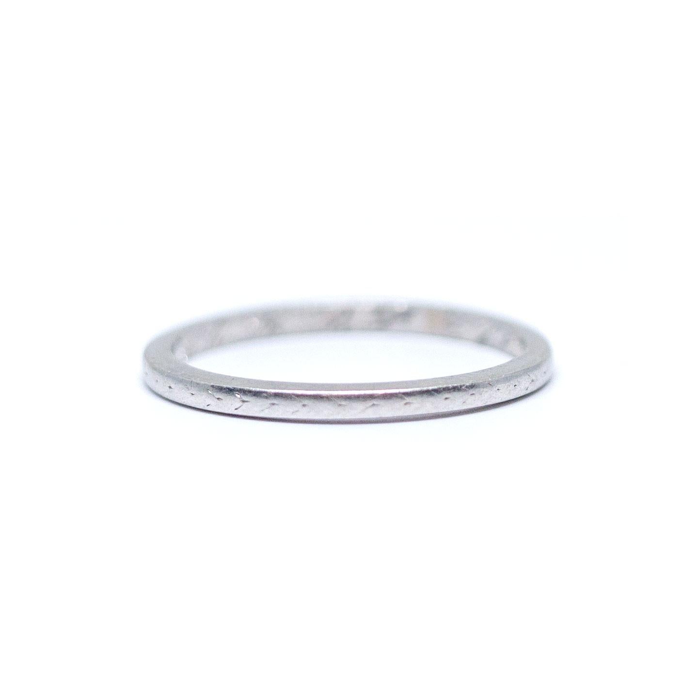 Here we have an 1920s Art Deco wedding band! A great band to pair with your engagement ring or just add to your vintage jewelry collection! Also looks super cute stacked with other vintage bands!

This is a true antique piece, and we are honored to
