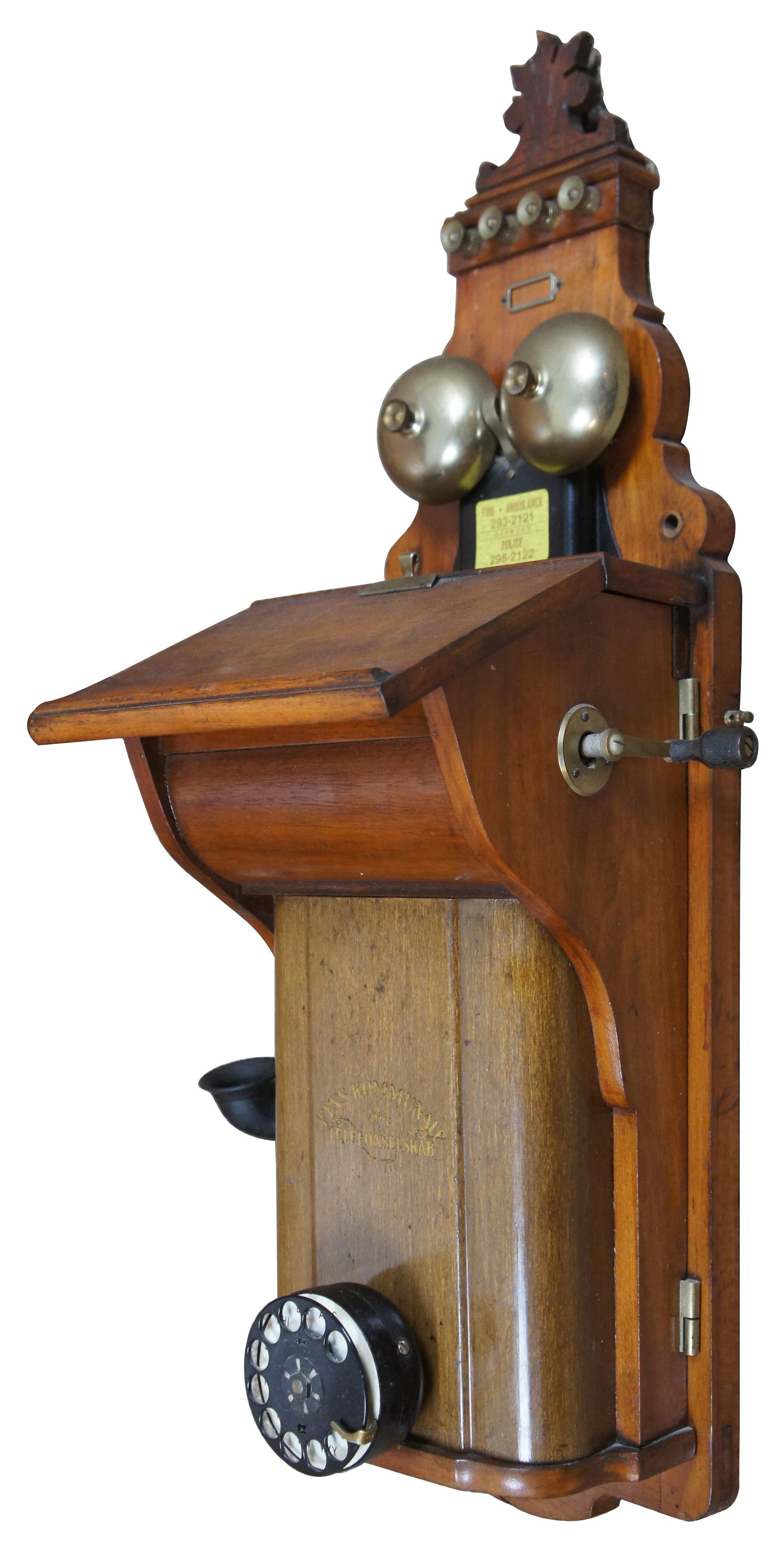 Antique 1924 Fyns Kommunale Telefonselskab wooden wall-mounted rotary dial telephone, update in 1968 by W.E. Co. Measures: 29”.
   