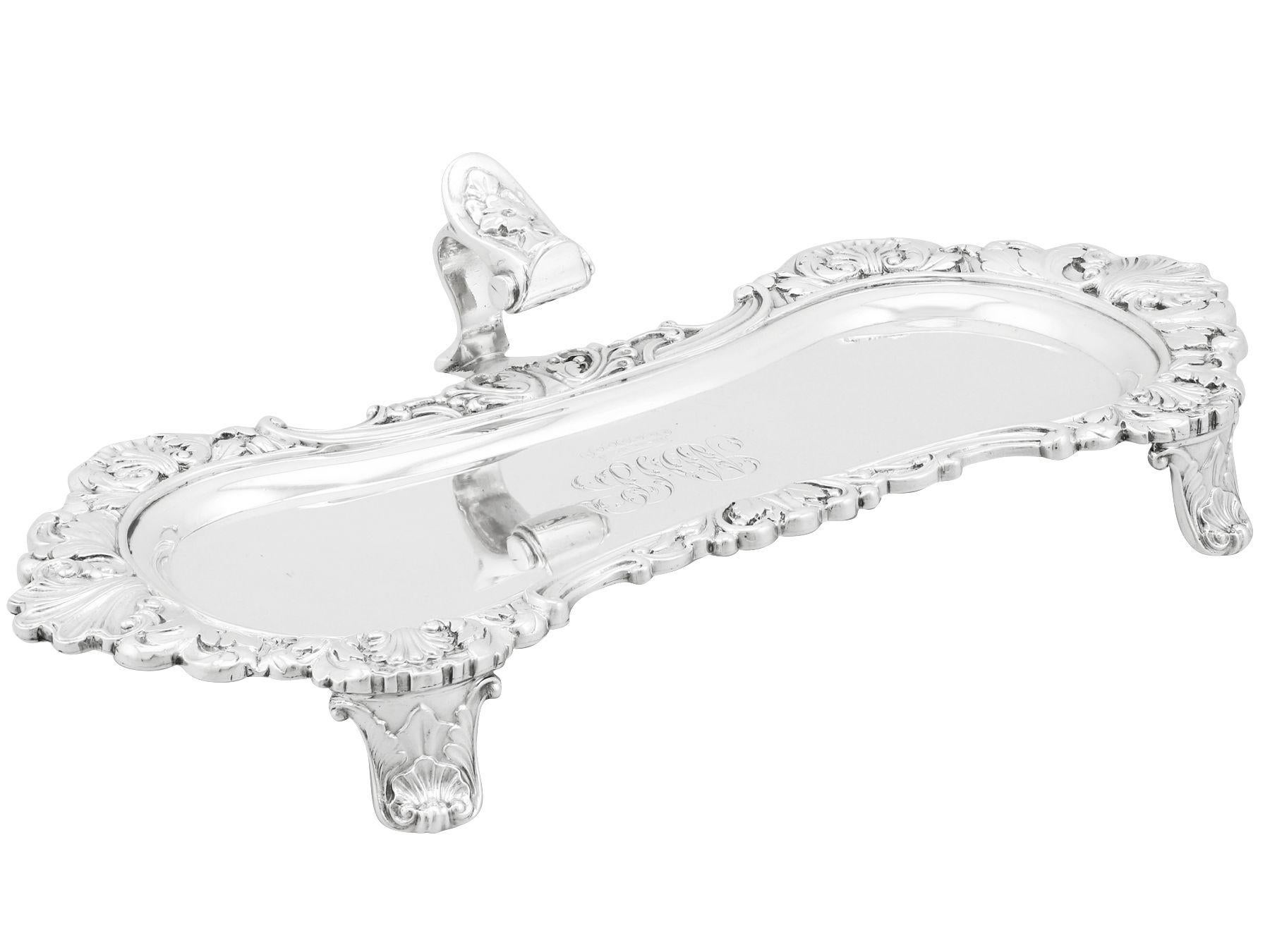 An exceptional, fine and impressive antique George IV English sterling silver snuffer tray; an addition to our antique silverware collection.

This exceptional antique George IV sterling silver snuffer tray has an oval, serpentine shaped