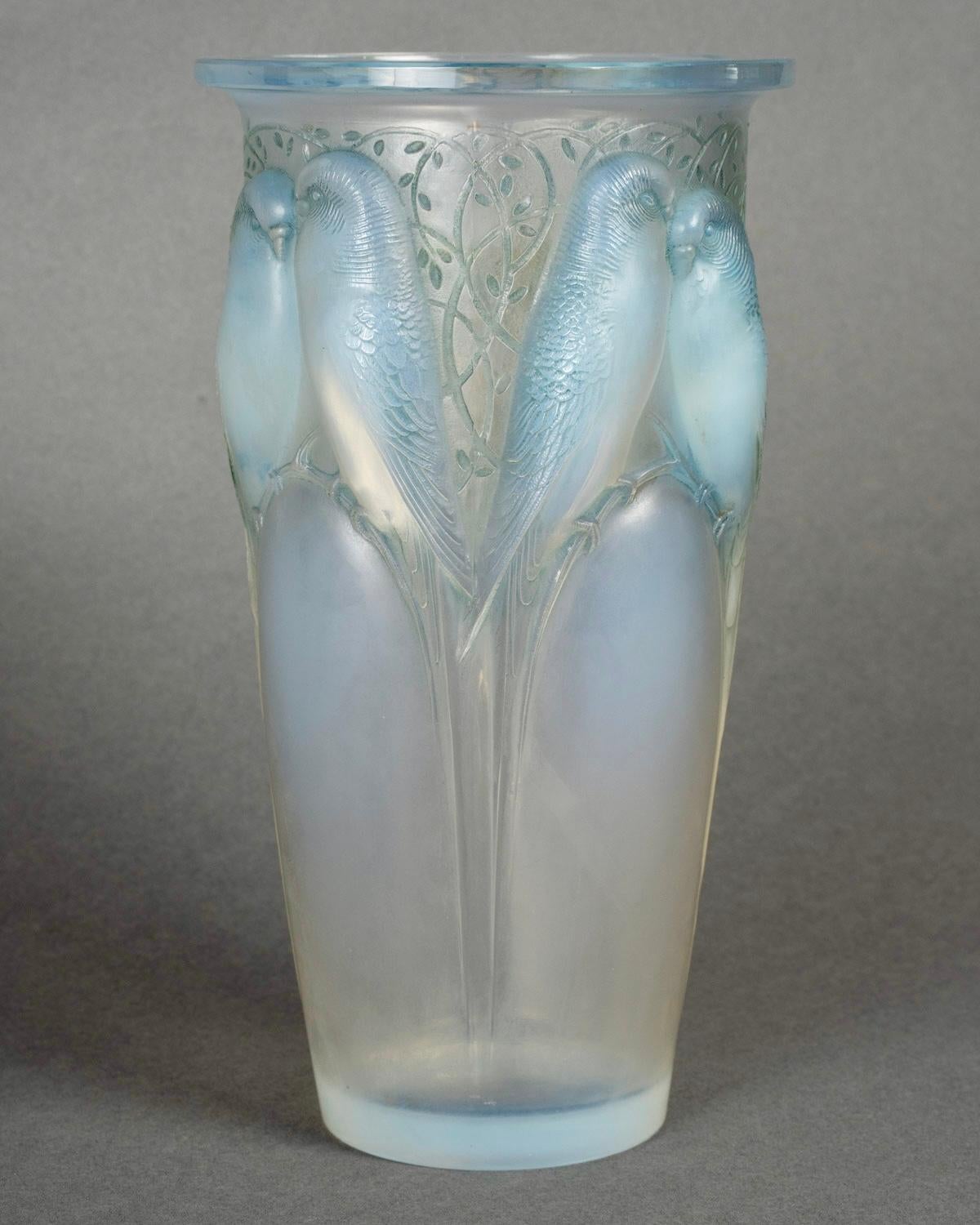 Vase “Ceylan” made in opalescent glass with blue patina by René Lalique in 1924.  
Engraved signature.    

Perfect condition. Very nice opalescence.     

height: 24 cm    

Félix Marcilhac, René Lalique - Catalogue Raisonné de l'Œuvre de Verre,