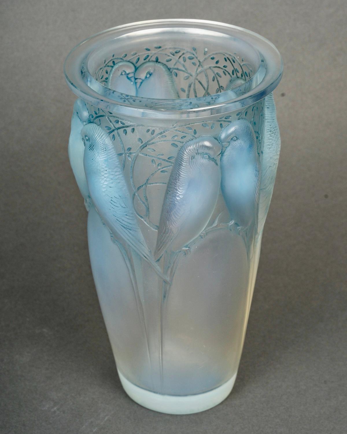 Vase “Ceylan” made in opalescent glass with blue patina by René Lalique in 1924.  
Engraved signature.    

Perfect condition. Very nice opalescence.     

height: 24 cm    

Félix Marcilhac, René Lalique - Catalogue Raisonné de l'Œuvre de Verre,