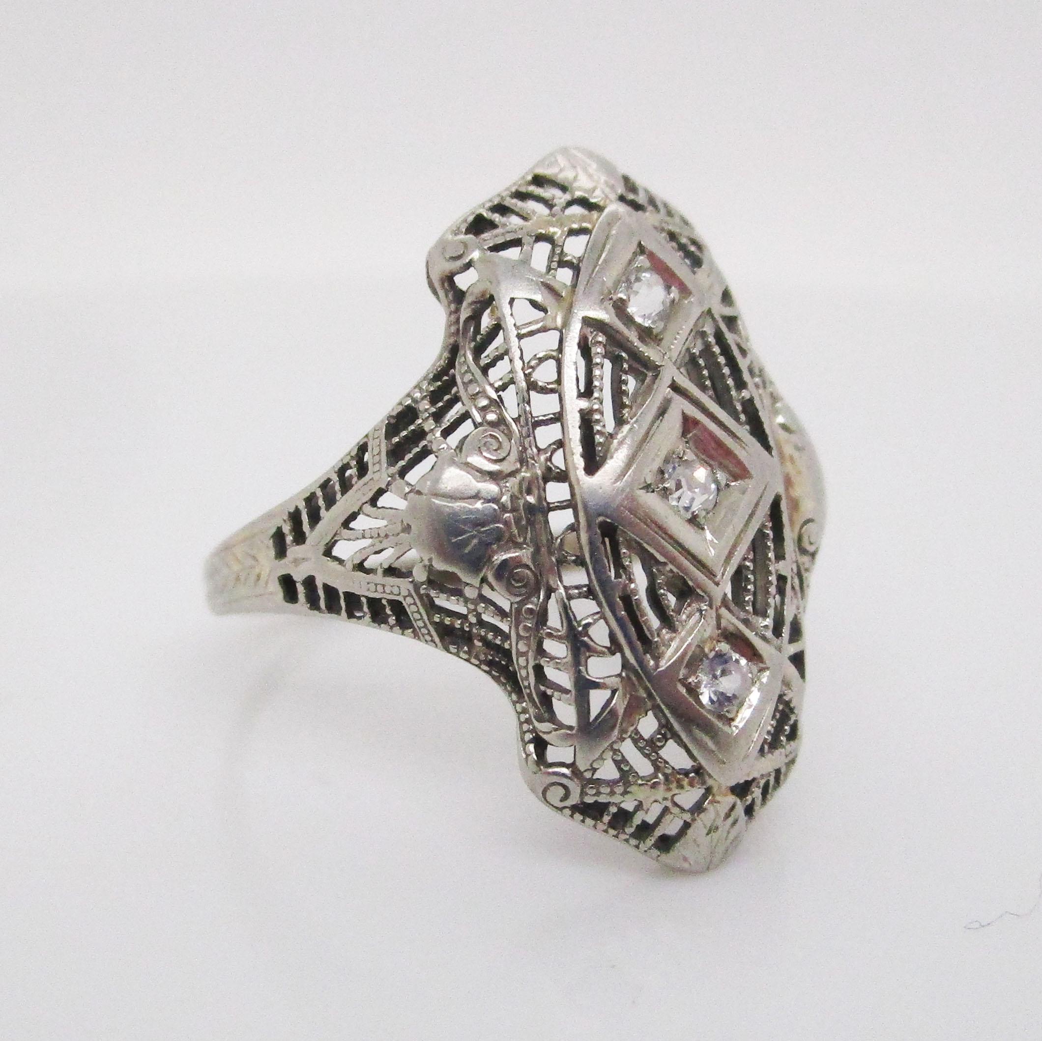 This definitive Art Deco ring is from 1925 and brings together bright 18k white gold and brilliant white diamonds to create a remarkably enchanting piece of wearable art! The ring features a gorgeous long linear layout that is a hallmark of Art