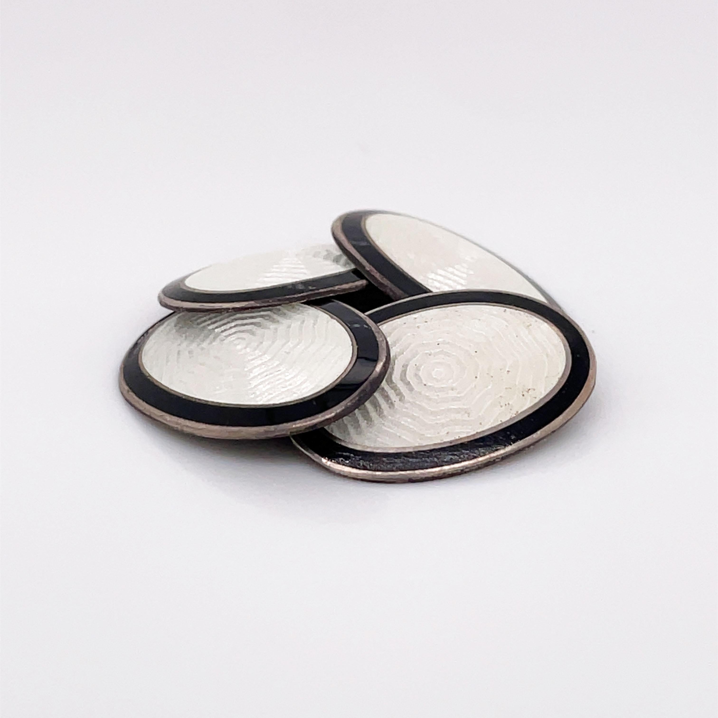 This is a beautiful pair of 1925 Art Deco Black & White Enamel Cufflinks! This is the perfect set of links for any established gentleman! Composed of Sterling Silver, this pair of cufflinks features a beautiful guilloche design, almost reminiscent