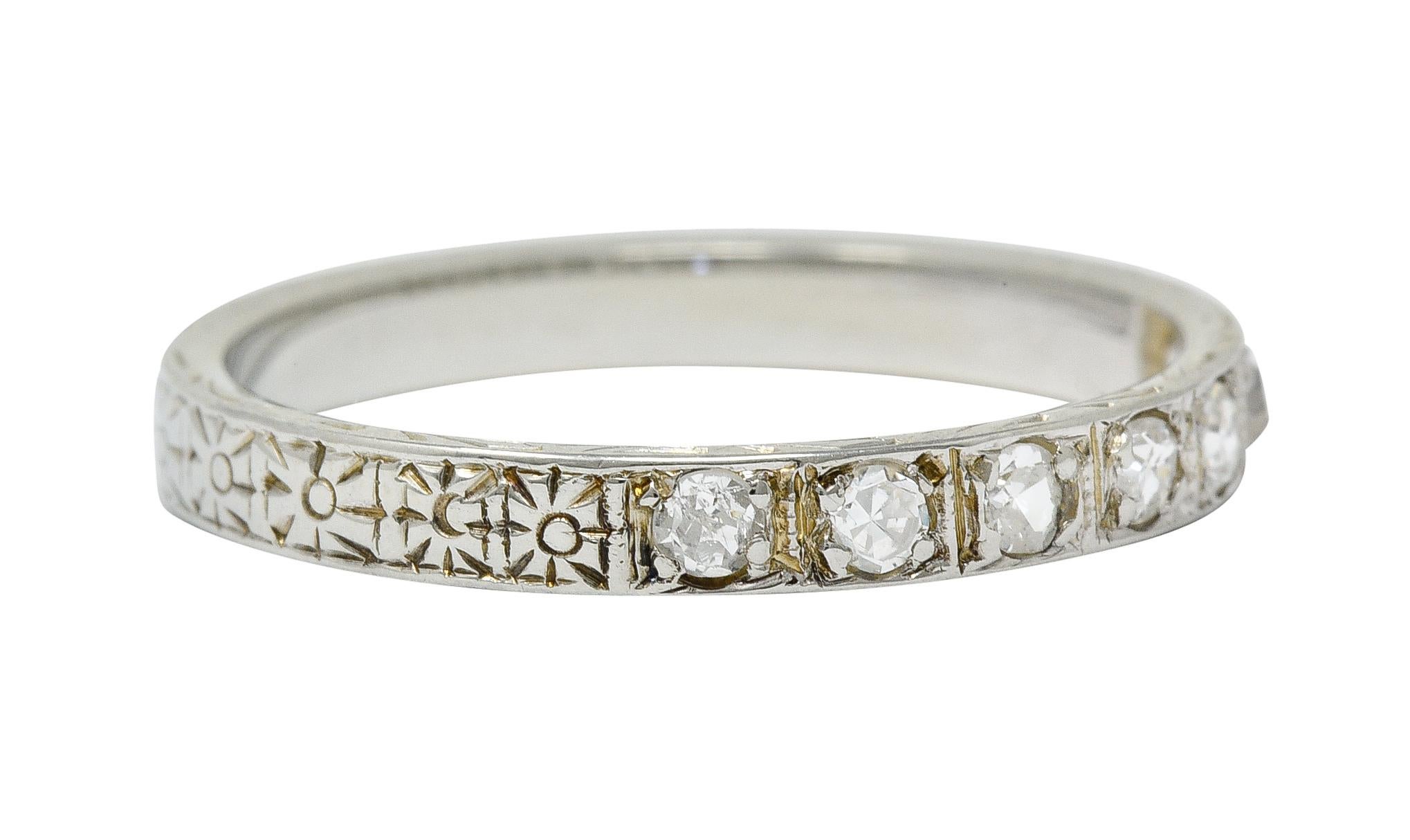 Band ring features seven old single cut diamonds

Weighing in total approximately 0.21 carat with H to J color and clarity consistent with age

Bead set in square forms and completes as an orange blossom shank; deeply engraved fully around

Stamped