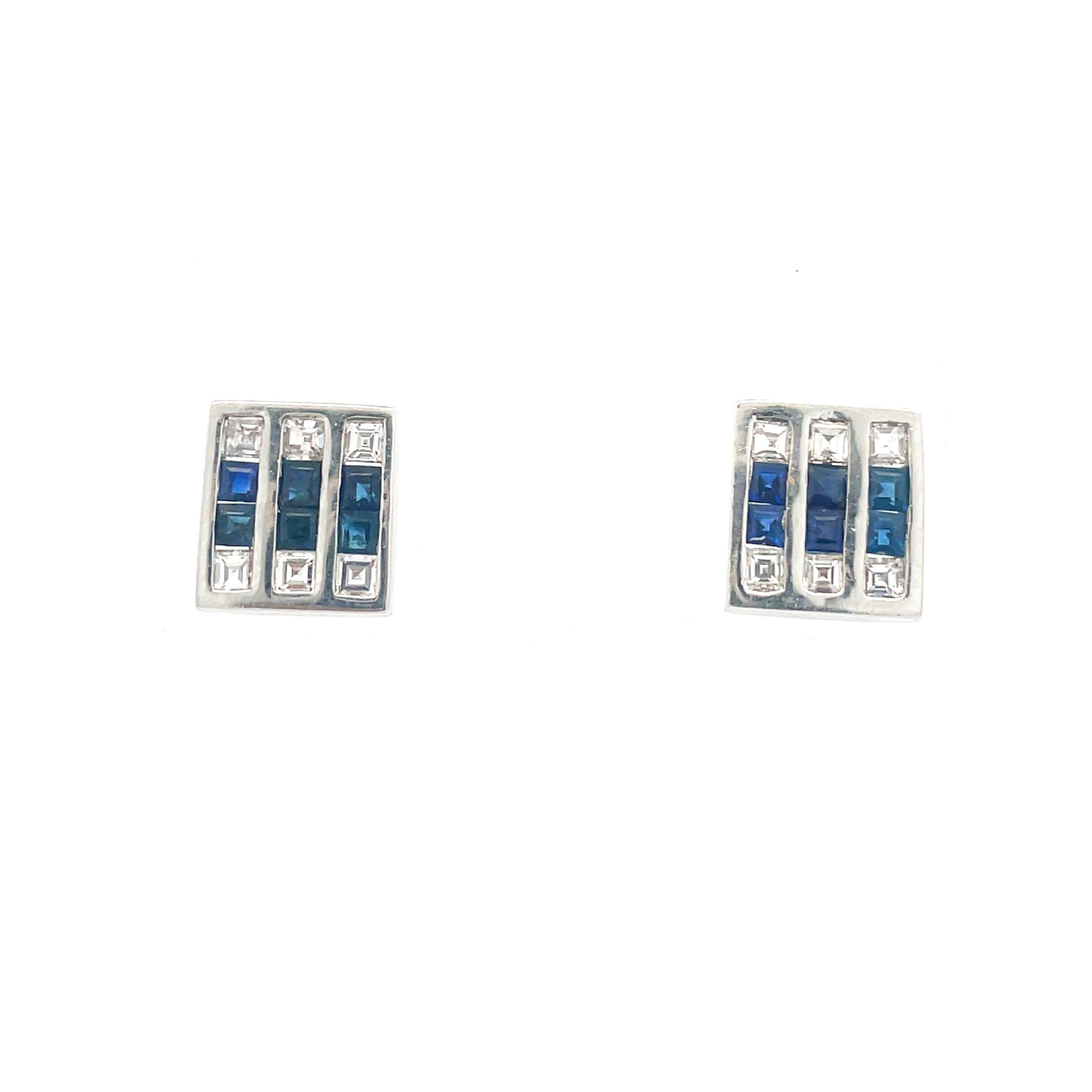 This is a stunning pair of Art Deco earrings crafted in forever white Platinum that showcases bright white square-cut diamonds and vivid blue sapphires. These exquisite ear studs, artfully and intricately hand fabricated in platinum, will not