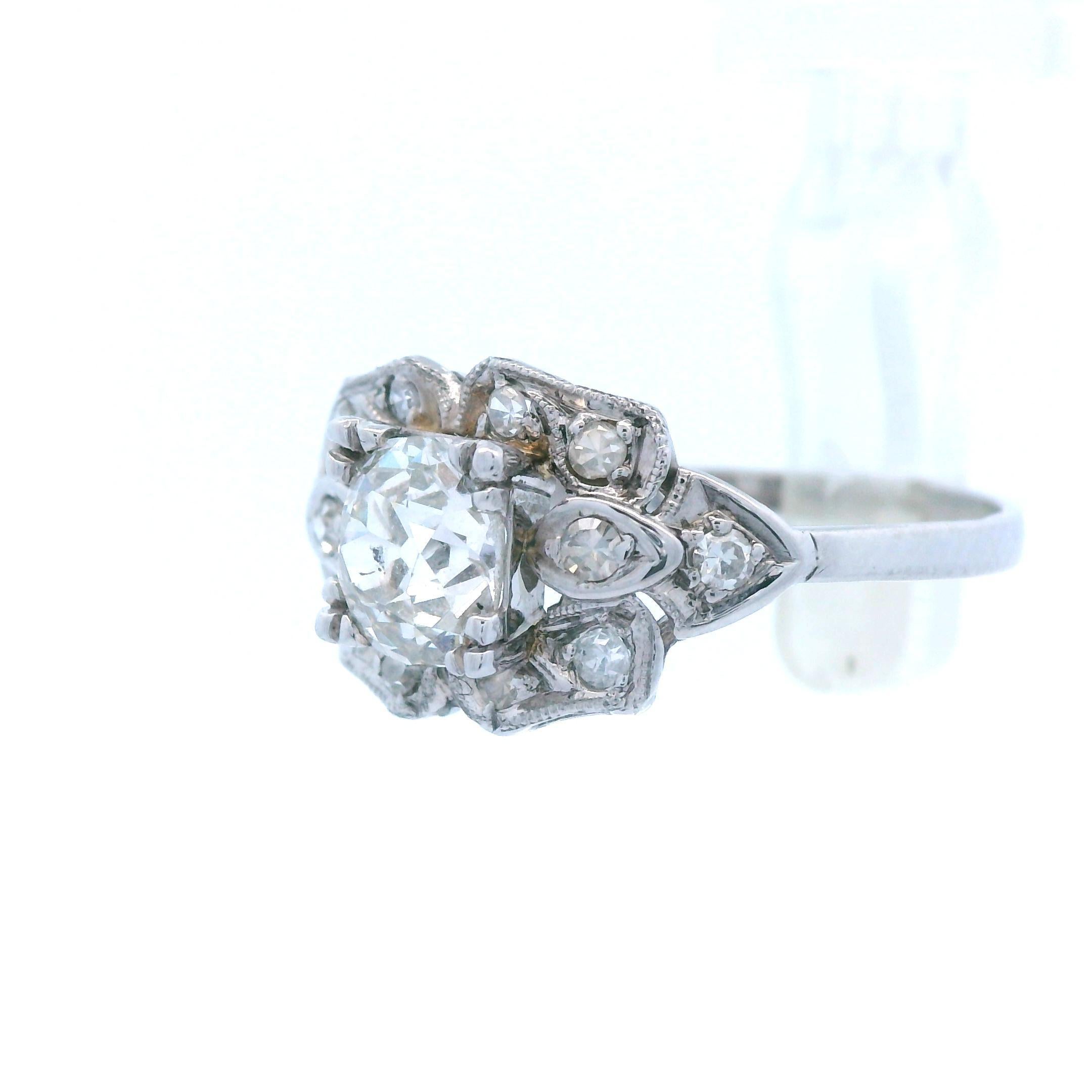 This is an absolutely stunning platinum Art Deco engagement ring. The ring is solid platinum and has been around for nearly a century, and is ready to by a symbol of true love for years to come! The ring has a gorgeous milgrain detailing framing the