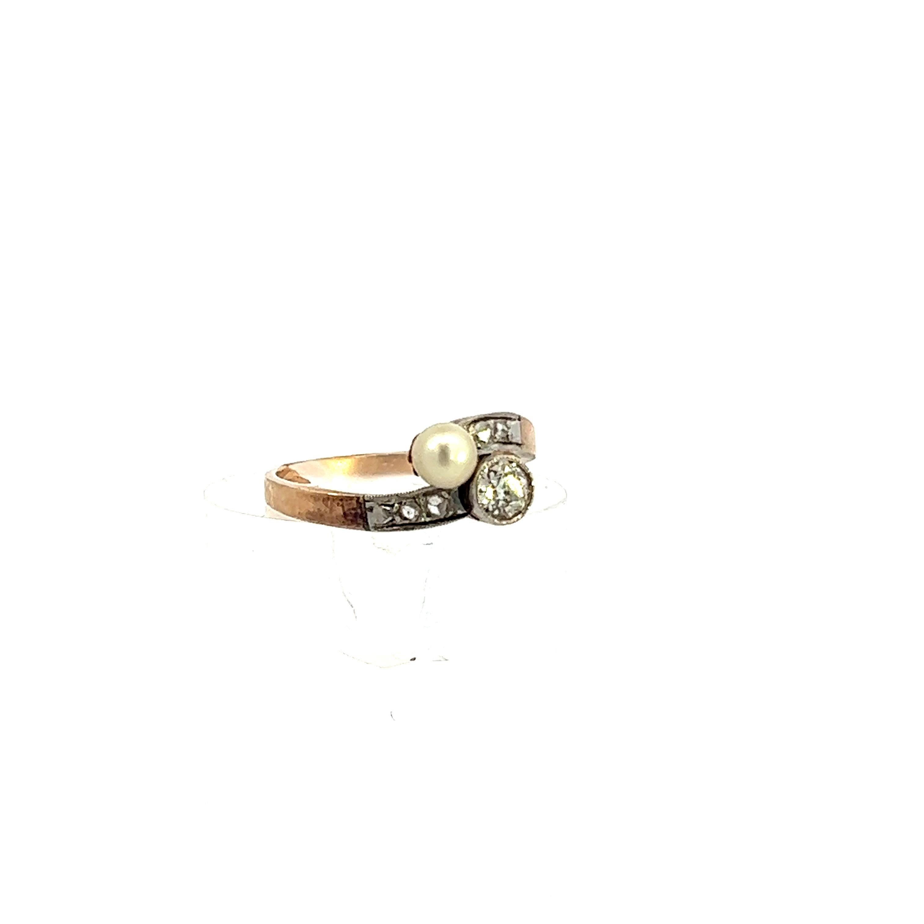This is an Art Deco bypass ring from 1925, platinum over gold, featuring diamond and pearl. Being made in platinum over gold, this ring features a combination of benefits from both. The yellow making the band provides a beautiful tone contrasting
