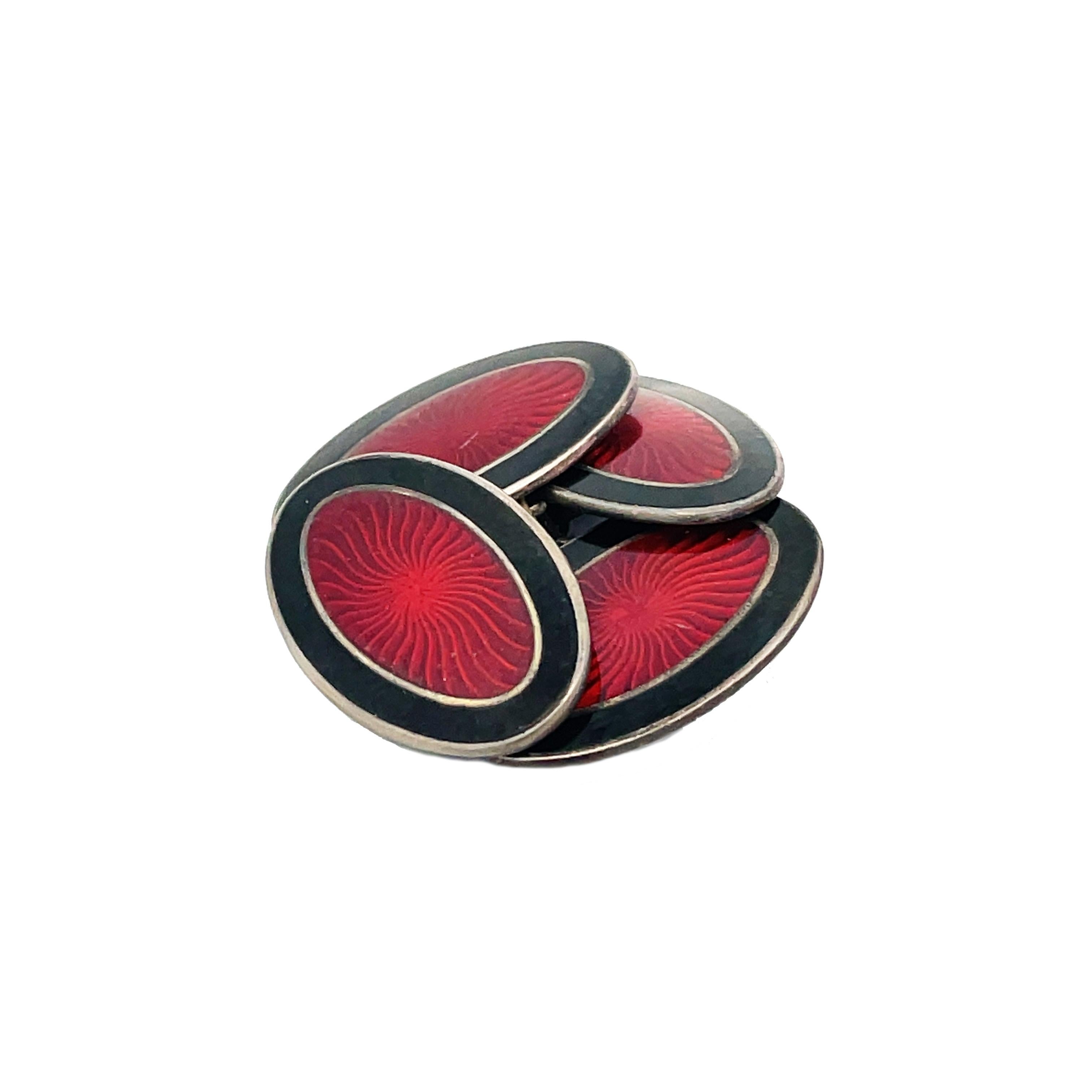 This is a stellar pair of Art Deco cufflinks crafted in sterling silver showcases a stunning red center and black enamel border. The enamel beautiful and vibrant and is in excellent condition. The dark black enameled border frames the vivid